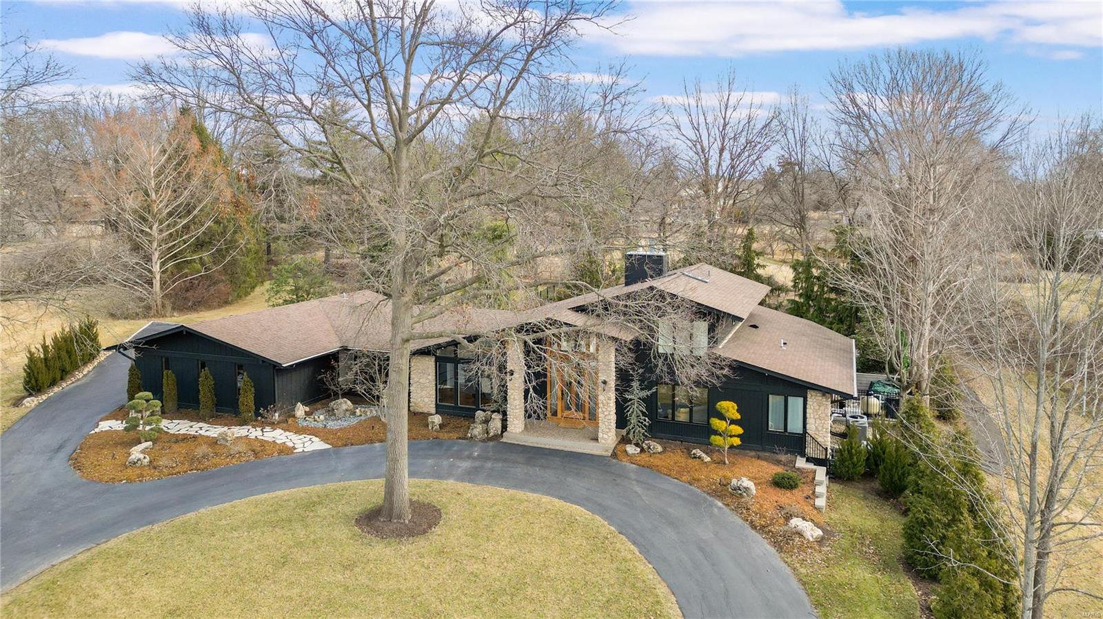 Immerse yourself in the epitome of refined living as you step into this residence, meticulously transformed Mid Century Modern by the current seller into an Architectural Digest-worthy stunner. This elegant residence features 4 bedrooms, 4 baths, and spans 4,434 living space. Expansive windows flood every room with natural light, enhancing the sleek and stylish design. With high ceilings, contemporary design, and built-ins, this luxury home exudes sophistication. Privacy is paramount with the split bedroom design. The luxury primary bath and direct access from the primary bedroom to the patio and pool area elevate comfort and sophistication. The lower level  has a family room featuring a fireplace, full bath, and a gym. Step into the serene private yard boasting a heated pool, hot tub, and a private patio-an oasis for relaxation. This is a rare gem that defines modern luxury living. Additional Rooms: Mud Room