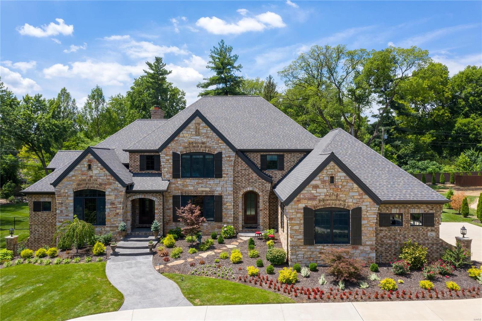 This gorgeous 5 yr old home in Ladue, situated in a private enclave of newer construction homes, offers over 5300 sq ft of luxury finishes that one would expect. The open floor plan highlights walnut flooring and designer fixtures throughout. The gourmet kitchen with custom cabinetry, center island, custom walk-in pantry, Thermador appliances, opens to a family/hearth rm with stone fireplace overlooking the covered patio with stone fire pit and custom pool and level gated backyard. A formal dining rm with butler's pantry and living rm with gas fireplace are perfect for entertaining, while a large custom office allows for a quiet workspace . You will also find a luxury master suite complete with soaring ceilings, spa shower, soaking tub, dual sinks, and his/her closets. 2 powder rms, a lg laundry/mudrm complete this 1st flr. 3 light-filled bedrm suites, a large 2nd fam/rec rm with fireplace and a 2nd custom laundry rm complete the 2nd flr. 4 car gar, lookout low level with bath rough in Additional Rooms: Mud Room