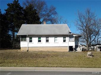 Lots of possibilities - 6 acres m/l with approximately 700 foot of Hwy 30 frontage.  Older 2 bedroom 1 bath cottage new a little TLC, several small outbuildings, older pole barn suitable for horses or cattle, property is fenced, water & electric at pole barn. Mostly open pasture with scattered woods. Call for your personal tour today!