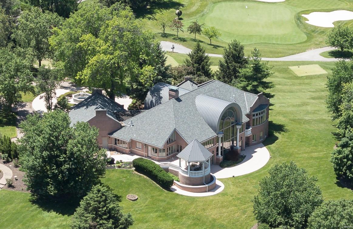 One-of-a-kind custom home with some of the very best views in all of Saint Louis, overlooking manicured grounds of Westwood Country Club Golf Course. Upon entry, a massive foyer welcomes and announces arrival, through sweeping ceilings and a virtual wall of glass. The feeling is captivating and unlike anything found in residential construction. With over 7,300SF of living area, marble floors, artisan millwork, and expansive rooms, hallmarks of the property include a main level master wing, hosting an enormous bedroom with sweeping panorama views out to the course, a luxe bath, private patio, room-sized organized closets, and abundant storage. The kitchen is outfitted in high end stainless, with adjoining hearth and breakfast rooms. The Lower Level is above grade and walk out, with three bedrooms, theater, gym, and several gathering spots. A floating staircase join main and lower levels, with an additional back staircase. In the Village of Westwood, and the Ladue school district.