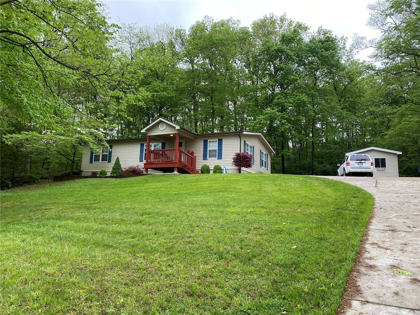 Beautiful Country Setting! 3 BR/ 2 BA home with 3 unrestricted acres with lots of woods and gorgeous views!  Beautiful kitchen with center island, custom cabinetry, modern lighting, and wood veneer floors.  All appliances stay! Home features a master bedroom suite with walk-in closet and remodeled bathroom.  Other features include nice covered front porch, screened in back porch, fresh paint, vaulted ceilings, MF laundry, utility shed, concrete driveway, and pretty landscaping! Just minutes from Hwy 61 for an easy commute!  Come and take a look at this parklike setting!