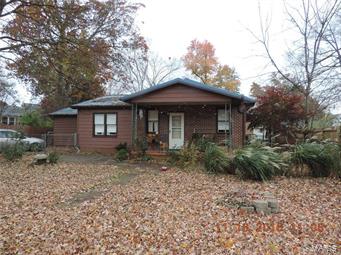 Cute! Cozy! and Charming! are just a few ways to describe this adorable partial brick ranch style home, nestled on a nice large, level yard in Farmington. This home is in a great location with tree lined streets, turn of the century homes and conveniently located near EVERYTHING! The home has good curb appeal with the covered porch and some landscaping. This quaint floor plan offers over 1,130 sf.ft. of living space, featuring three good sized bedrooms, all with ample closet space, nice kitchen with plenty of cabinet space. Lots of interior charm with bright colors, hardwood floors, built in shelving, & updated light fixtures. This home also offers a great covered back patio, some yard fencing, and an awesome two car detached garage with CENTAL HEAT & AC! (Garage also has back alley access) This great home also offers a partial basement perfect for storage or storm shelter. HURRY and call today for your personal viewing of this great property!
