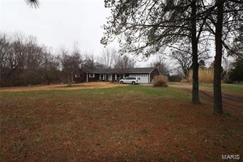 Large home in need of updates, but there is a lot to offer in this 4 bedroom/2 bath home.  There is a barn and a dog kennel behind the house and a partial dog run is fenced in. Just at the edge of the city limits!!! Large deck on the back and a sun room attached to the family room and laundry room. Such potential here!! SpecialListingConditions: Probate