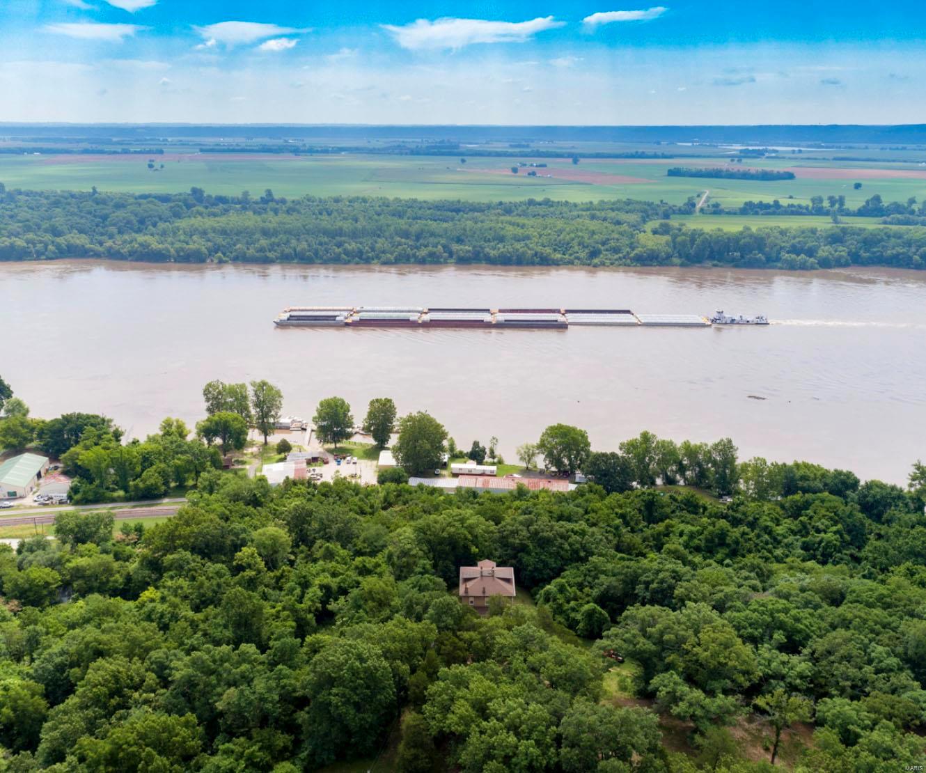 Rare and unusual find, panoramic Mississippi River view from 10 + bluff top acres-one of the largest tracts of this kind for hundreds of miles north or south of St. Louis. Walking distance to the future home of steam boat Delta Queen and next door to historic Kimmswick, Mo. Includes  the 150 year old +  Jefferson County home of Friedrich Adolph Wislizenus (1810-1889) German-born MD, explorer and botanist. Most all of the period charm including 10 foot tall pocket doors, staircases, millwork and turn of the century light fixtures has remained intact.  The 2 story solid masonry house is in surprisingly good condition but in need of modernization. Built by genuine craftsmen at a time when fine homes were intended to stand for centuries and it shows! Be sure to check out the virtual tour / drone photography. Shown only by appointment.