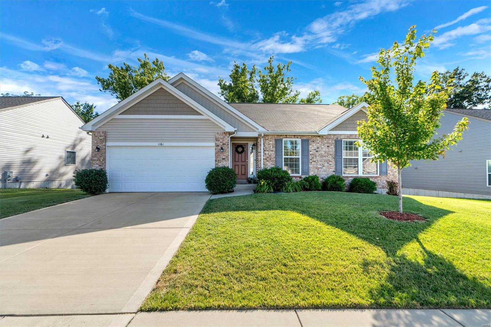 Welcome home to 1161 Crystal Creek Parkway, a stunning one-owner custom-built home in the heart of Wentzville! This exquisite property boasts modern amenities & an open floor plan, perfect for comfortable living & entertaining. The gourmet kitchen features stainless steel appliances & a spacious walk-in pantry, ideal for culinary enthusiasts. You'll love the wooded views looking out from the dining room to the fabulous deck! The spacious primary bedroom boasts a large ensuite bathroom with dual vanities & huge walk-in closet. Enjoy the convenience of built-in speakers throughout the home, enhancing your audio experience. The full, finished walk-out basement includes a bedroom & full bathroom, providing additional living space for guests or recreation. The sprinkler system ensures a lush, green lawn year-round. Conveniently located minutes from shopping, restaurants, and Interstates 64 & 70. Don't miss out! Information pulled from various sources. Buyer to verify all MLS data.