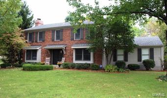Beautiful brick and frame 2 story with old world charm plus updated modern features.  Elegant leaded glass entry doors and marble foyer greet you on the spacious main level.  Enjoy the large open main level plan that includes rich oak hardwoods floors throughout the hearth room, kitchen, breakfast area and office/den. The fireplace is equipped with a gas insert for instant warmth and mood setting. The main floor office can easily be converted to a formal dining room. Bay windows provide additional charm and natural light in the office and hearth room.  Totally updated kitchen with custom cabinets, solid surface tops and ceramic backsplash. French doors lead to the private patio with brick pavers and surrounded by lush mature landscaping and a flat backyard.  Update baths and fresh paint adorn each level.  Master suite includes large walk in closet and walk in shower. Lower level includes spacious family room, wet bar and half bath.  Huge shaded corner lot in Rockwood school district.