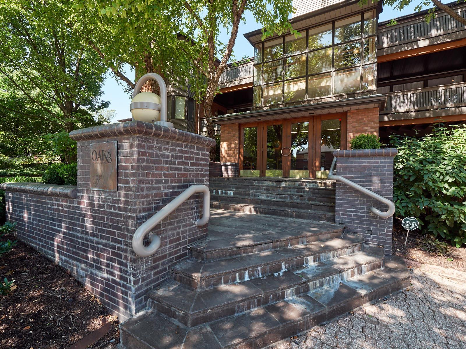 Custom designer condominium with spectacular location!! Easy walking distance to the Clayton Business district. Updated tiled surround gas fireplace with custom designed glass stones. Wall of windows offering a great view of this tree lined beautiful area. Extra large covered deck is perfect for entertaining! Chef's Kitchen updated with gorgeous cabinets, granite, and upper-end stainless steel Dacor and Miele appliances! Breakfast bar and dinning area. Recessed lighting throughout as well as hardwood floors and newer fixtures, moldings and trims. Spa-like master bath features separate shower and soaking tub with custom tile surround, large vanity area with granite, custom fixtures and plenty of closet space complete with organizers. Underground parking with 1 assigned space.This wonderful space truly differentiates from the ordinary! Location: Interior Unit
