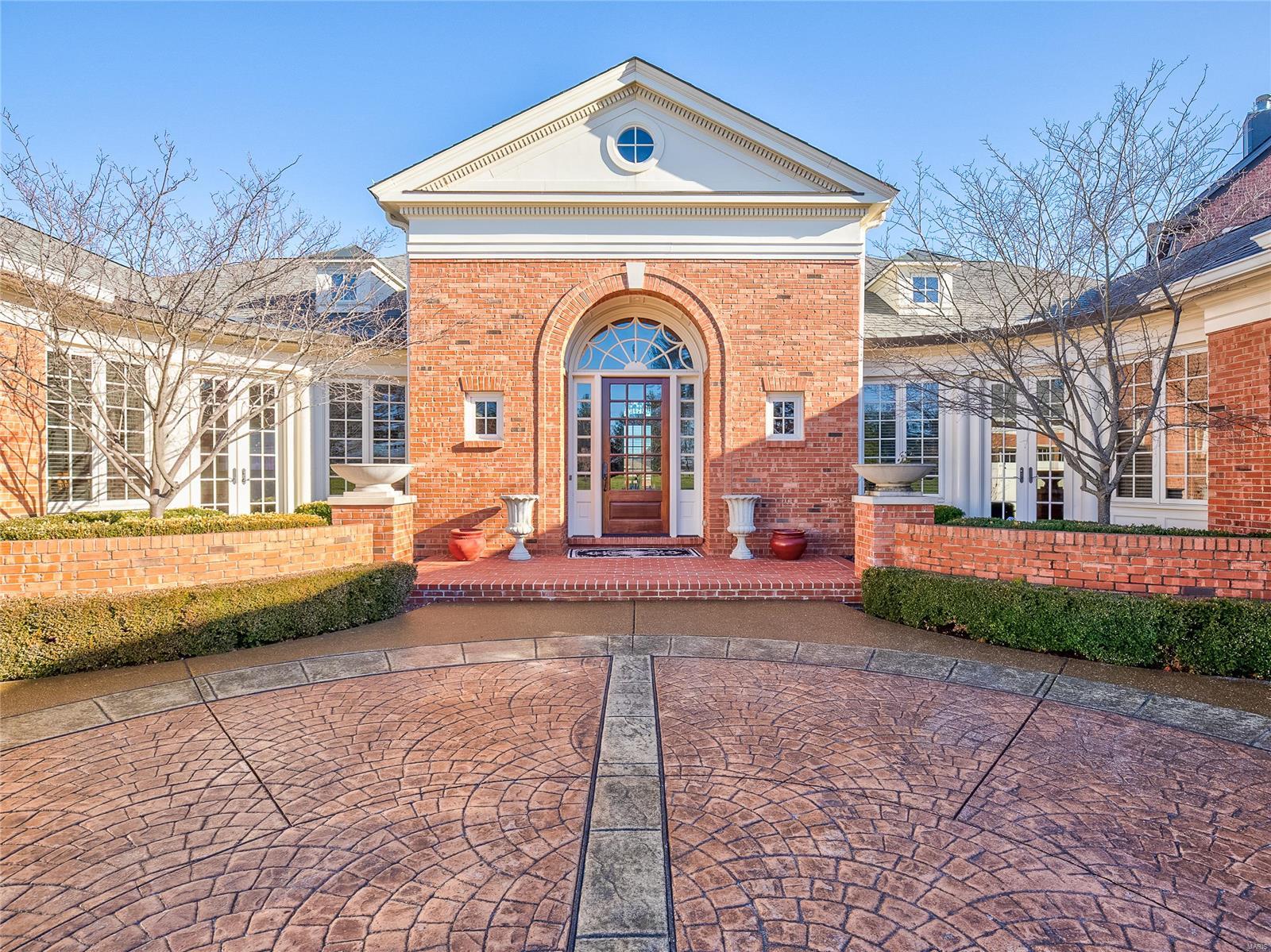 Lovely former Vatterott display that is well appointed & upgraded w/ exceptional custom mill work & craftsmanship throughout.This widely appealing floor plan would be a perfect choice for a family or an empty nester w/ 4 bedroom & 4.5 baths.Enter into the foyer w/ gorgeous inlay wood fls that lead to the spacious lower level, the gracious living rm & dining rm that are perfect for entertaining. The eat in kitchen that has honed granite counters, custom cabinetry, a farmhouse sink, a large walk in pantry & high end appliances like Wolf.The master suite has access to the deck, 1 of the 3 fireplaces, "his" & "her" closets & a large master bath w/ 2 vanities, walk in shower, & jet tub. The LL features 2 additional bedrooms & 2 full baths. It also has 3 separate rec/game areas. One of which has a kitchen with bar,Sub Zero refrigerator & dishwasher.Other features include wood floors, built-in bookshelves,coffered ceilings, tankless water heaters, & a 3 car garage w/custom concrete courtyard.