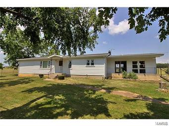 Ranch home with 10 acres more or less with full basement and two garages. This great farm has approximately 1400 feet of road frontage and easy access to major highways. Home has steel siding, newer windows, new architectural roof in 2010, awesome 18x22 sun room, kitchen for caning in the lower level and large kitchen with lots of cabinets on main floor. Outbuildings include 36x64 hay barn, 30x32 granary 54x22, machine shed/shop and older 66x40 barn. This home has some handicapped accessible features, and alarm system. (Additional acreage may be available) Call for a showing today. DISCLAIMER: All measurements stated herein are approximate. Square Feet and land area measurements are based on records of the St. Francois County assessor; all other measurements have been performed by non-qualified persons and may be inaccurate. Some Accessible Features