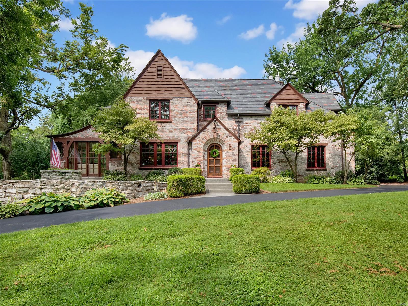 Majestic Tudor situated on the hillside of Hampton Park. This stunning 4 bed, 4 bath boasts over 4200 feet w/ a thoughtful addition (2005). Dramatic Formal LR has wood beams, cork floor, and gorgeous fireplace w/ French doors out to the patio. Separate DR opens to a lovely sunroom. Sunken family room has beautiful marble tile floor and base w/ another lovely stone fireplace. The custom eat-in kitchen has a center island, granite countertops and display cabinetry. Don't miss the main floor laundry & back stairwell to the 2nd floor bonus room above 3 car garage. Off of the main stairwell, find the primary suite w/ gleaming hardwood floors, hall bath and two generously sized beds, plus an enormous additional bedroom w/ 2 large closets- perfect for sharing! The slate roof is 9 years old & the saltwater pool was completely renovated in 2005 w/ new plumbing, electric, equipment, PebbleTec, marble coping, & hardscape. Stunning grounds. Automatic gate to access Hanley. Showings begin 8/6. Additional Rooms: Sun Room