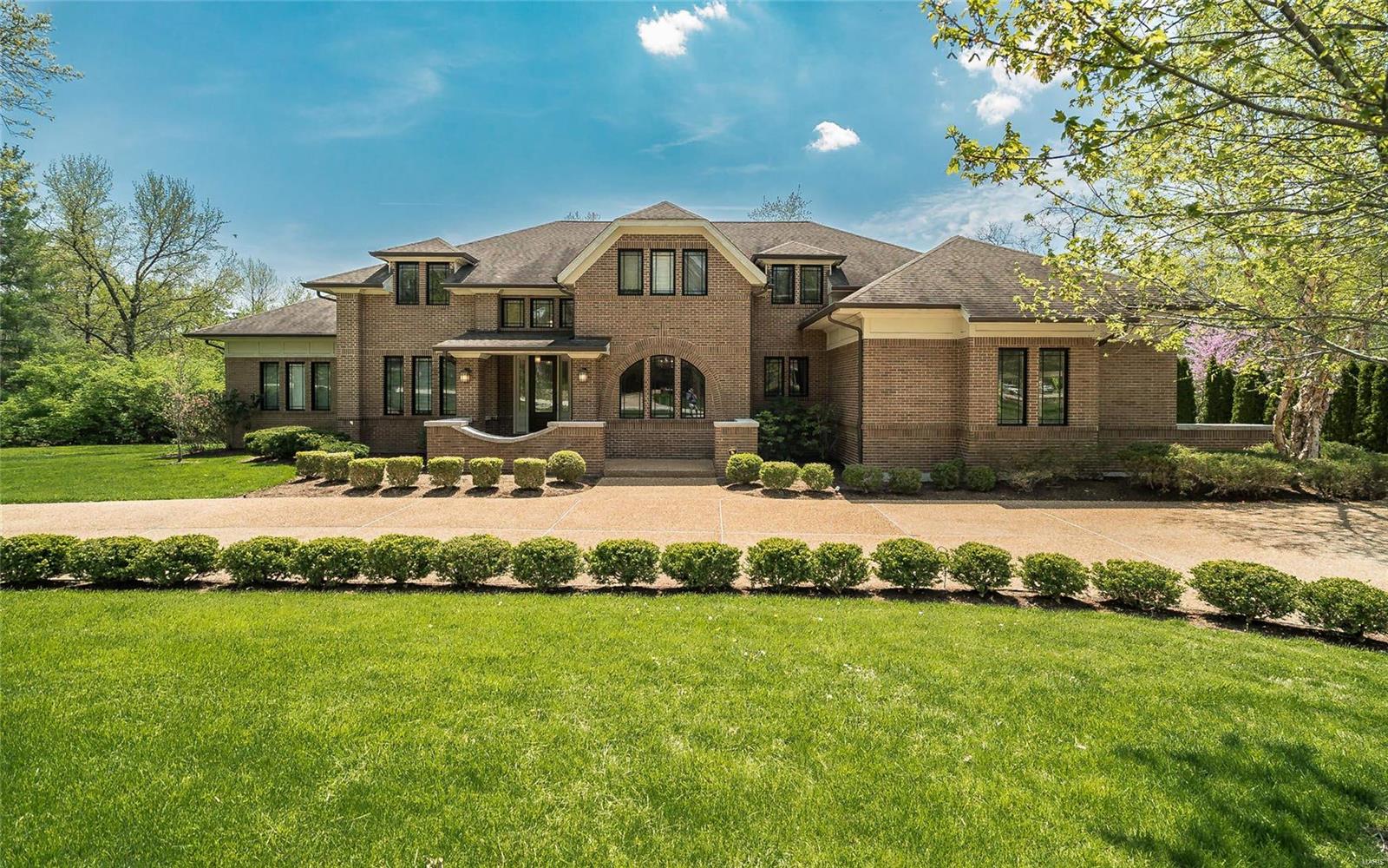 Exceptional 12-year-old Ladue residence with over 5,500 square feet of fabulous living space. This 5 bedroom, 4.5 bath home offers a wonderful open floor plan, beautifully proportioned rooms, ten foot ceilings, stylish custom millwork and a main floor master suite with spa-like bath and his/her walk-in closets.
The soaring light-filled great room with wide plank maple floors, custom cabinetry and gas fireplace is perfect for entertaining.
The kitchen is exquisite with appliances a chef will love, solid surface counter tops, breakfast area and cabinets galore! An inviting hearth room with vaulted ceiling, stone fireplace and custom built-ins adjoins the kitchen and opens to a large private deck. 
Upper level offers 3 spacious bedrooms and 2 baths.  The finished walk-out lower level boasts fifth bedroom & full bath, game room, exercise room, bonus room and abundant storage.
Main floor laundry, mudroom,  4 car garage, aggregate driveway, inground sprinkler system and lovely lot.