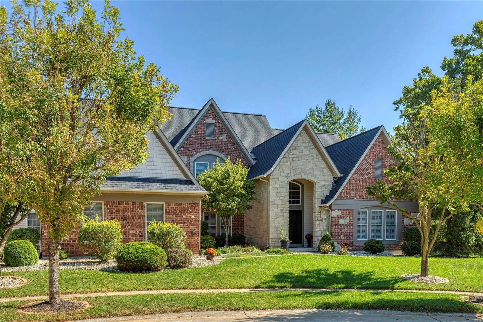 Exceptional brick & stone 1.5 Sty in premier neighborhood! Gleaming wood floors, soaring ceilings, extensive millwork & plantation shutters add to the appeal of this European-styled Fischer & Frichtel-built home. Expansive foyer leads to private study, elegant dining room with octagonal ceiling & architectural columns & stunning great room with marble fireplace with full-height mantel, built-in bookcases & dramatic 2-sty bow window. Chef’s kitchen featuring 42” white cabinetry, granite countertops, stainless steel appliances & butler’s pantry adjoins light-filled breakfast room & hearth room with stone fireplace & atrium door to deck. Coffered master bedroom suite offers an appealing retreat with wide bay window & luxury bath with Jacuzzi. The 2nd floor extends the living quarters with 3 additional bedrooms, 1 with ensuite bath & 2 with Jack n’ Jill bath. Lower Level includes recreation room, game room, office & full bath. Located on a premium cul-de-sac lot with deck & 3-car garage.