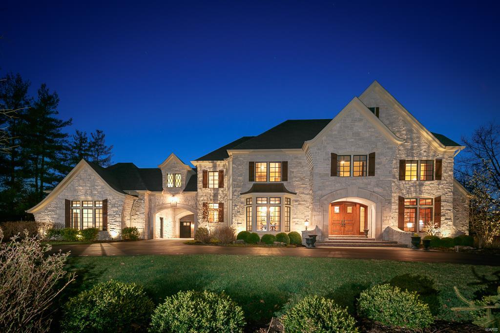 Outstanding stone manse combines rustic luxury and innovative custom comforts. Home is infused with warmth and character and is perfect for entertaining. With high ceilings and moldings throughout, the stunning entry with stone wall leads to the office and formal dining room. Blending Venetian plaster walls, vaulted ceiling and antique hand hewn beams, the incredible kitchen, breakfast and hearth room are where everyone congregates with custom cabinetry, grand island with granite, top of the line appliances and awesome 1000 bottle wine room. The private and spacious 1st floor master offers a coffered ceiling, marble and tile bath with heated floor and his/her custom closets. Upstairs are 3 bedroom en suites, laundry room and large unfinished area that could make a playroom or nanny suite. 1st floor laundry, 2 powder rooms, beautiful iron fixtures, professionally landscaped lot with back patio, outdoor fireplace, built-in grill and storage, 4-car garage, and huge lower level.