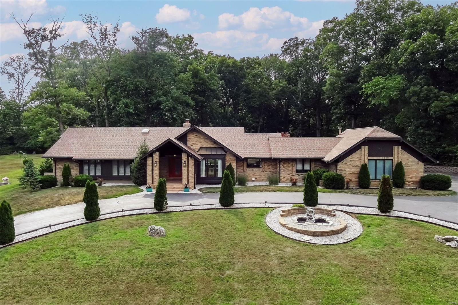 Experience the resort-like ambiance of this remarkable home on a private acre lot located within the exclusive Meadowbrook CC Estates. Renovated with exceptional craftsmanship, the open floor plan seamlessly combines functionality with an inviting atmosphere, ideal for both everyday living & entertaining. Many designer elements including stunning flooring, kitchen upgrades & stylishly appointed bathrooms. The master suite is a true sanctuary, reminiscent of a luxurious spa retreat. Access the LL, via the elevator or stairs & entertain in style in the finished media area accompanied by ample additional sitting/storage areas. Also find a well-equipped kitchen, 2 bedrooms & 1.5 baths. Step outside onto the expansive 1500 SF porcelain patio, which connects an impressive 1700 SF indoor area surrounding the pool, complete with retractable roof, ensuring year-round enjoyment, adorned with a waterfall & hot tub. Prepare to be captivated by its charm & elegance. No detail has been overlooked.