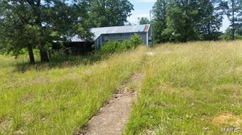 Very nice property! 60+ Acres of wooded land nice mix of terrain and wildlife abundance . Property has a 30X40 metal building and has a SEPTIC TANK, WELL AND ELLECTRIC ALREADY THERE!!! . Build your dream home in this secluded spot located near the Bennett Springs National Park  & just few miles from Lebanon.