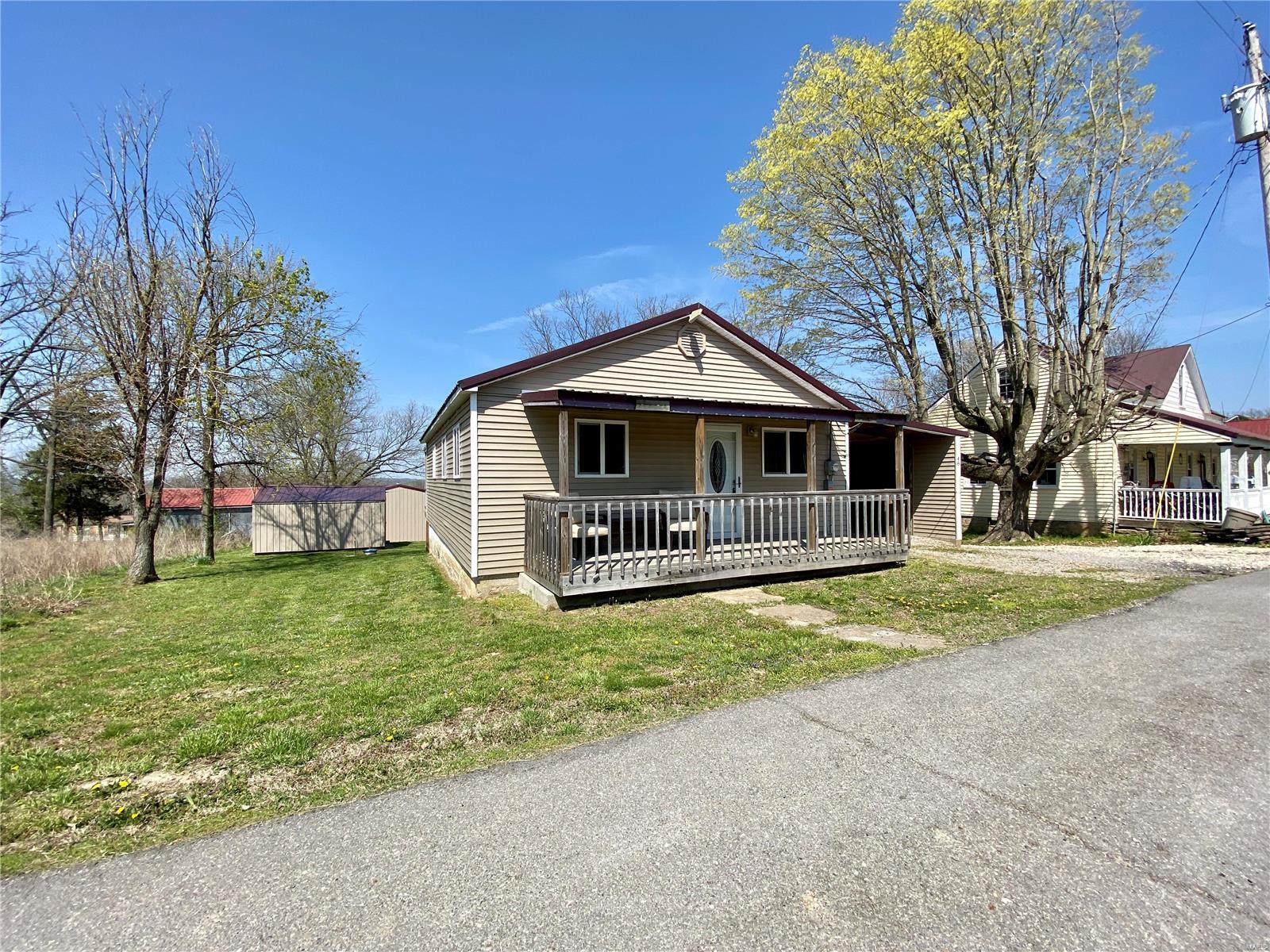 Take a look at this completely remodeled and adorable bungalow. With 864 sf of living area, this home offers 2 bedrooms and 1 full bath. You can enjoy the conveniences of main level laundry just inside the back door. The kitchen offers updated cabinetry and all stainless steel appliances are included for you. An adjacent dining area gives you plenty of space to host dinner. Hardwood floors extend through the kitchen, dining room and living room. The main level bath is spacious and offers all newer fixtures as well. You can enjoy your morning coffee or an evening glass of wine on the spacious covered deck which overlooks the lengthy backyard. This lot measures just over an acre. There are not one, but two shops for the hobbyist. Both are metal and offer concrete floors. The newer 40x40 shop also offers a covered lean-to area for additional storage. A one car carport completes this package.