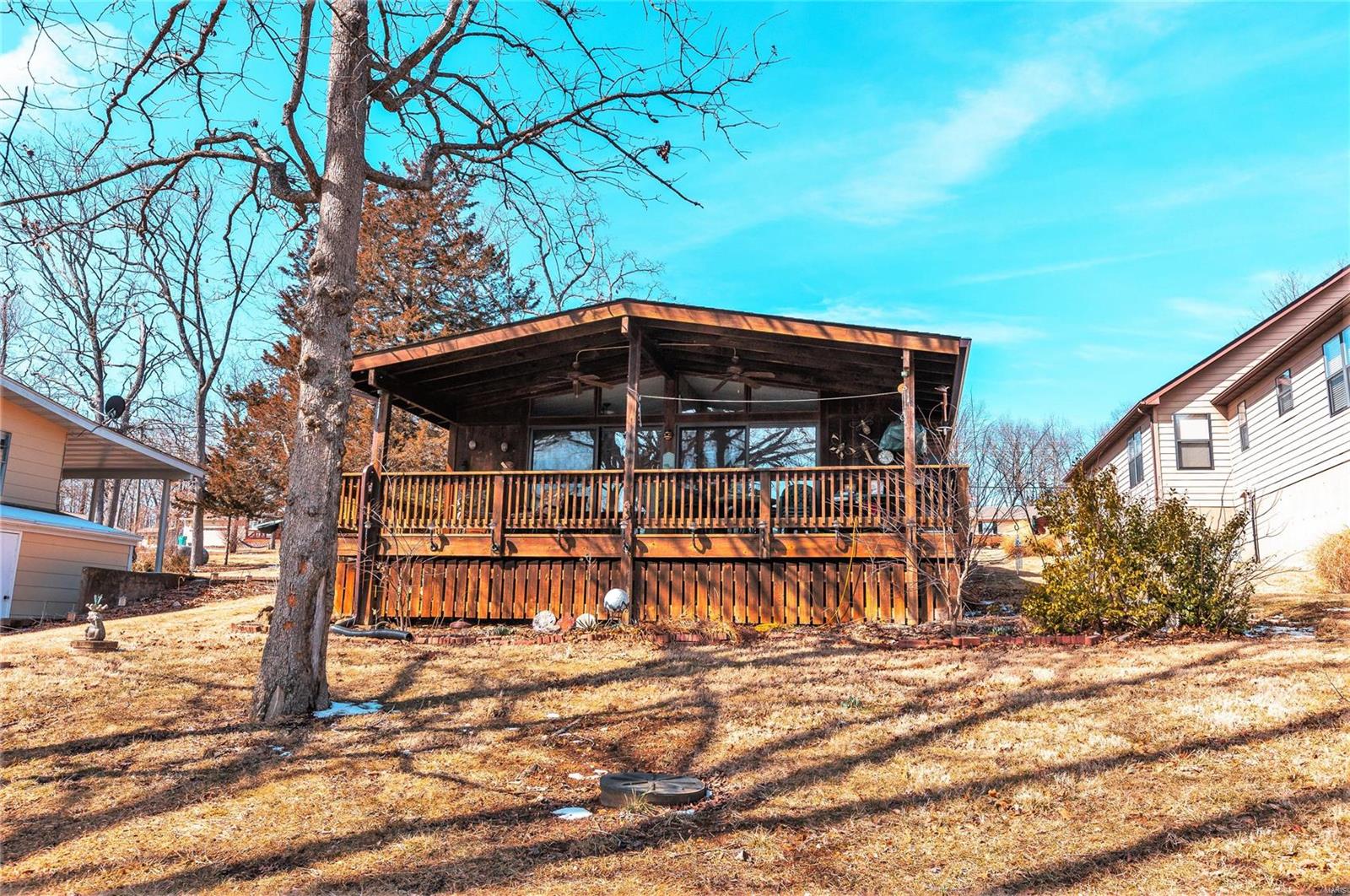 Not only is this property located in one of the best spots on the lake, it is full of updates - ground source heat pump, new roof, 6 inch gutters, and double paned windows. This house is set up for full or part time living. There is a divided floor plan - master suite and family room on the first level; follow the stairs down to the second level and find the kitchen, living room, 1.5 baths, a laundry room, and two more bedrooms. If you appreciate craftsmanship, you wont be disappointed here - the kitchen cabinets and wood flooring were handmade by the owner. If you need a place to do your own woodworking or store your toys for the lake - the shop is the perfect space to do it. The house is run with 200 amp service and the shop is 60 amp. There is also electric to the dock, which is large enough for a pontoon boat.