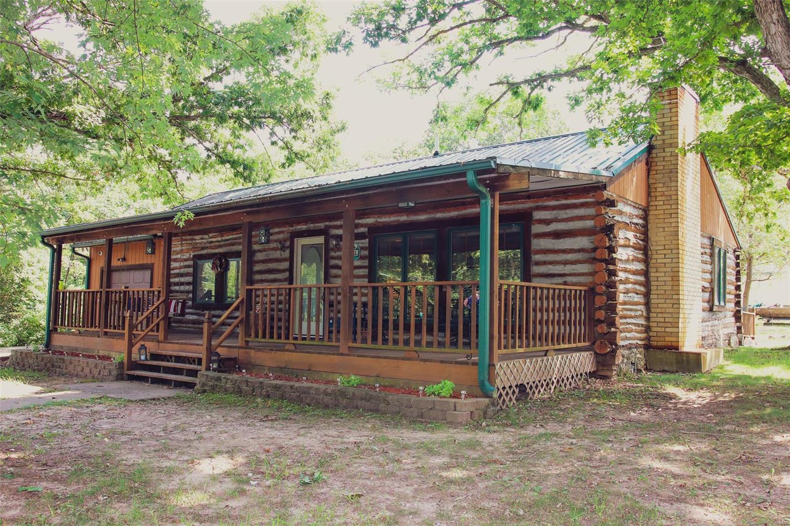 This 2 bed, 2 bath home is located on 10 acres just outside the city limits and features: log home construction, a covered front porch, wood burning fireplace, 45x50 outbuilding with concrete in a 30x45 section, pond, greenhouse, circle drive for easy access to all buildings, and a great private secluded setting. Schedule your private showing today, pre-approved loan or cash buyers only to view – if you do not have a preapproval letter please seek it before scheduling a showing. Buyer to verify all measurements and online data.