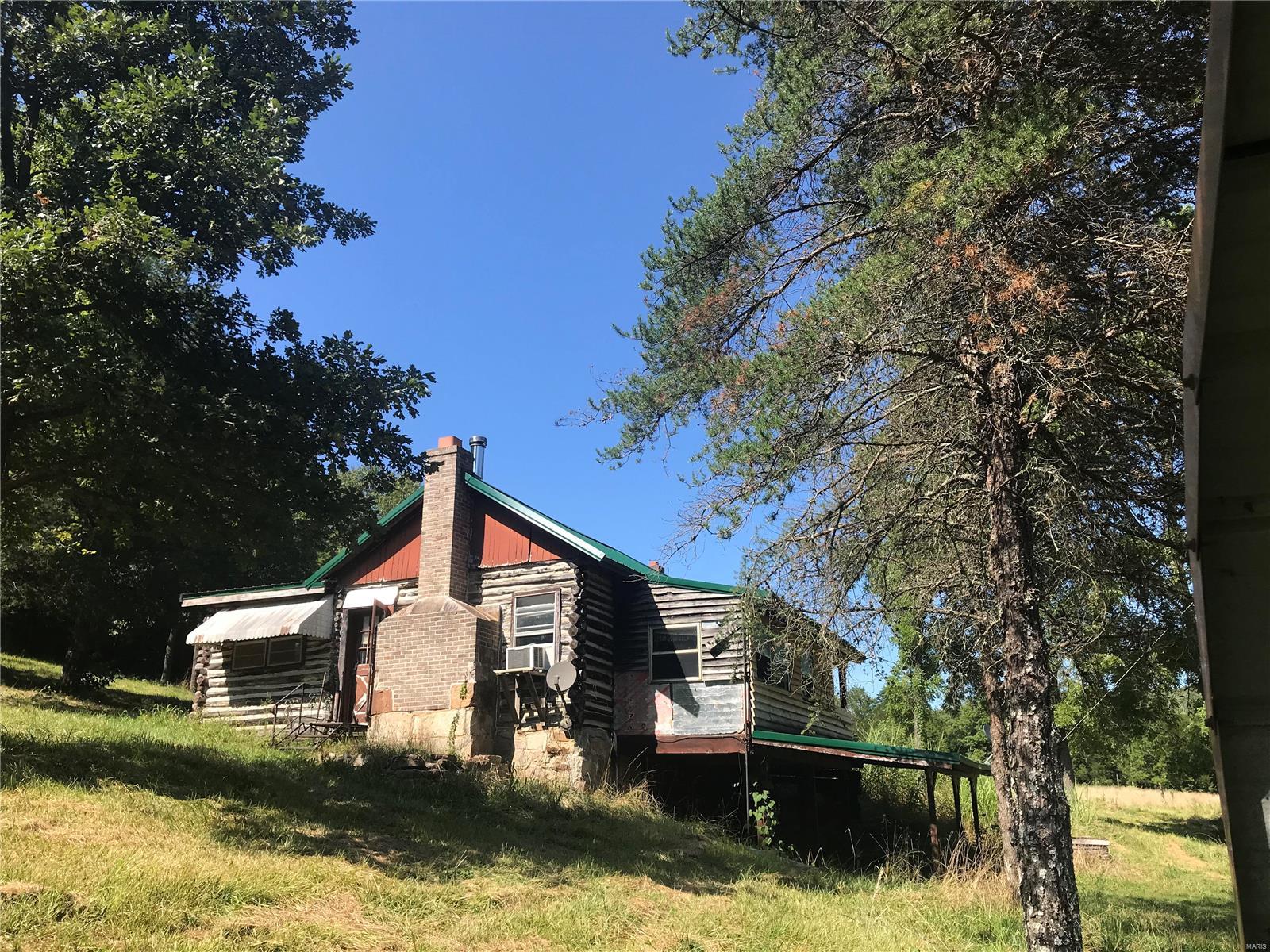 LOG CABIN, CREEK, PASTURE & WOODS:
Deer hunters, take note. This secluded 3-BR, 1-BA cabin sits on 50.24 acres with a mixture of woods and pasture. There is a year-round creek and a nice shoot house already in place for this deer season. Also included is a nice barn/skinning shed with new metal. This cabin has a new metal roof on it as well. This is located in SW Madison County and is near Sam A. Baker Park, and not far from Clearwater Lake.