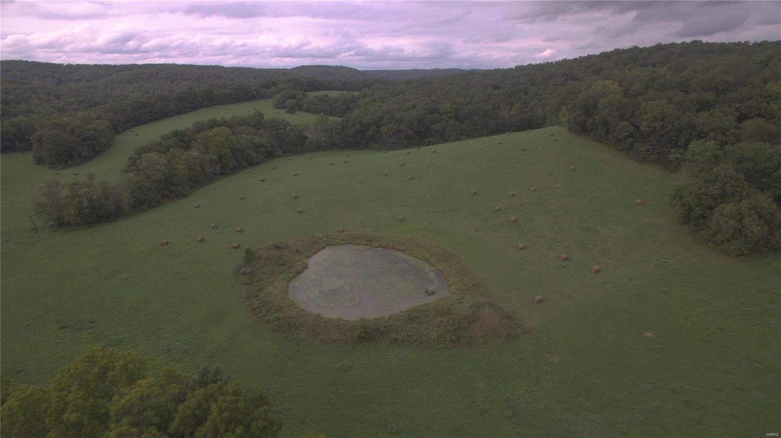 This hunting paradise doesn't come along often.  Hard to fine 578 +/- acres w/ approximately 125 acres of good pasture, 453 acres of harvestable timber, Barren Fork Creek runs through it, spring that feeds into the creek, 3 ponds, outbuildings,  mostly perimeter fenced & a small amount of cross fencing.  Perfect hunting retreat with a 3 bedroom ranch, 1.5 baths, 2-car attached garage, central air & heat, fireplace, full unfinished basement.  Lots of deer & turkey to complete the package.  Very private & secluded location.   Plenty of room for food plots and tree stands.  Plant corn and/or beans to further entice the wildlife.    When you are not hunting,  go play in the creek & enjoy the natural spring.  I cannot begin to describe the beauty & features of this property.  The property & timber were appraised in 2016 and 2019.  Own a piece of history as this property has been in the same family for over 90 years.  Joins government land on south.  Close to Current River and Echo Bluff.