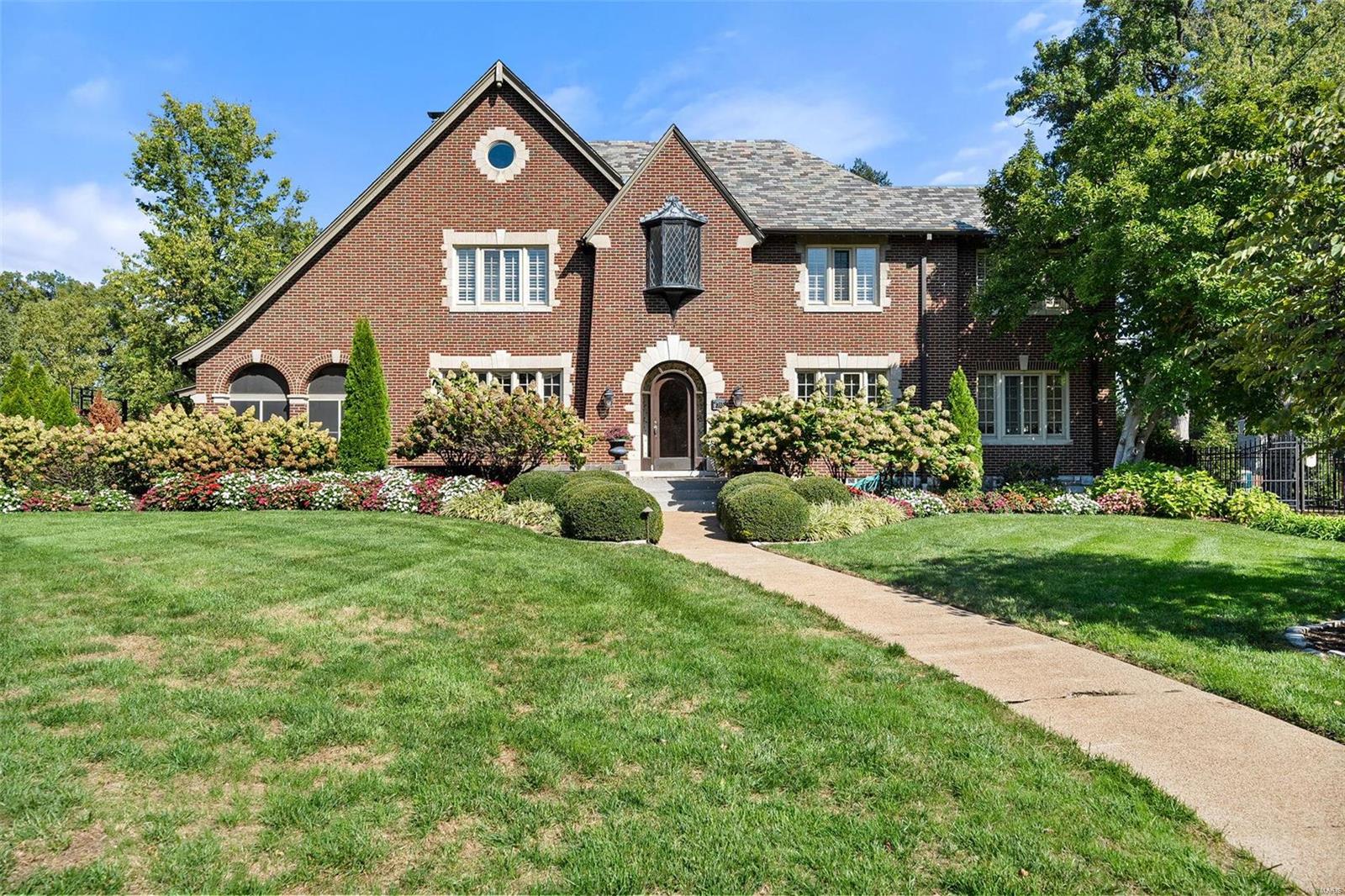 "Once in a lifetime". This elegant Tutor is situated on University City's premier block, Westmoreland, and steps from Clayton. This 5 bed, 6 bath is comprised of multiple living & entertaining spaces inside & outdoors. Thoughtfully renovated by the present owners over 30 years to provide modern amenities while preserving the architecture and character of the original home. Hardwoods throughout, grand fireplace in LR, screened in porch, gorgeous stair, separate dining, additional family room. Kitchen (2010), mudroom, powder room, back stair, and large den/study complete the main level. Large primary suite w enormous dressing room, 2 large beds w WICs and JnJ bath. Smaller en suite bedroom.Vaulted 3rd level w/ full bath provides stunning views. Finished LL w/ prep kitchen, rec space, half bath, storage. Terraced back patios, outdoor fireplace, pool, spa, and pool house. Professionally designed and maintained grounds with full irrigation. Oversized 2-car garage. Security system. Gated.