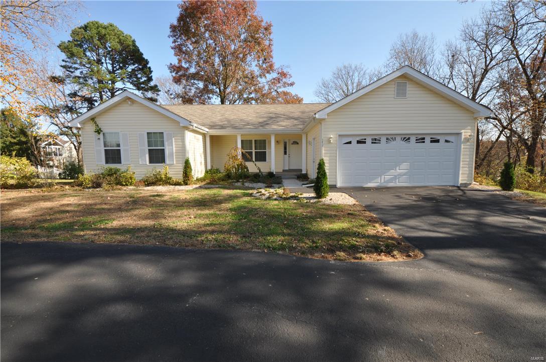 Completely remodeled from bones up 3 BDRM, 2 BTH home w/1600+ sq ft of living space on over an acre wooded, level lot. EVERYTHING IS NEW! NEW: roof, main level windows, vinyl siding, doors, flooring, fireplace, floorplan, kitchen cabinets & appliances, bths, HVAC/AC systems & paint. Exterior feat 1+ acre complete w/walking trails & wooded privacy. Also includes circle drive w/extra parking, 2 car garage, covered porch, landscaping, deck & patio. Interior w/spacious great rm w/vaulted ceiling & gas propane fireplace flanked by ceramic tile and space for built in shelving. Gorgeous hand scratched dark laminate flooring. Breakfast rm w/sliders out to deck overlooking HUGE premium lot. Kitchen is a dream w/antique white 42" cabinets, SS microwave & dishwasher. Main fl laundry w/cabinets & pantry. Main fl master bdrm suite w/his & hers walk in closets & master bth w/dbl sink vanity, whirlpool tub & walk in shower. 2 add'l bdrms & HUGE full bth. Walk-out basement waiting for you! MUST SEE!