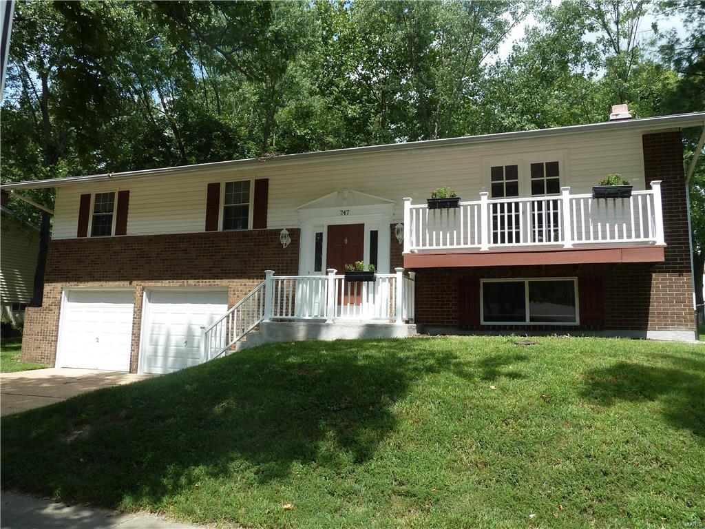 Move in ready!  Enjoy this 3 Bedroom 2.5 bath home with generous living spaces and stylish finishes. Beautiful hardwood floors and plenty of natural light flow throughout the open, airy floor plan.  Updated Kitchen with newer appliances, ceramic tile flooring, backsplash with glass tile, gas stove &  glass cabinets with extra counter space.  Wood floors in the living room with French doors that open to a balcony & in the dining room which walks out to a deck overlooking a large back yard.  Three comfortable bedrooms on the upper level with the master bedroom having its own full bath with an oversized shower and built in seat.  New insulated window & vinyl blinds throughout.  The  Lower Level family room has a wood burning fireplace and half bath.  Extra deep 2 car garage. Great location and close to Manchester Park and the Parkway Schools. 
 No need to search further!