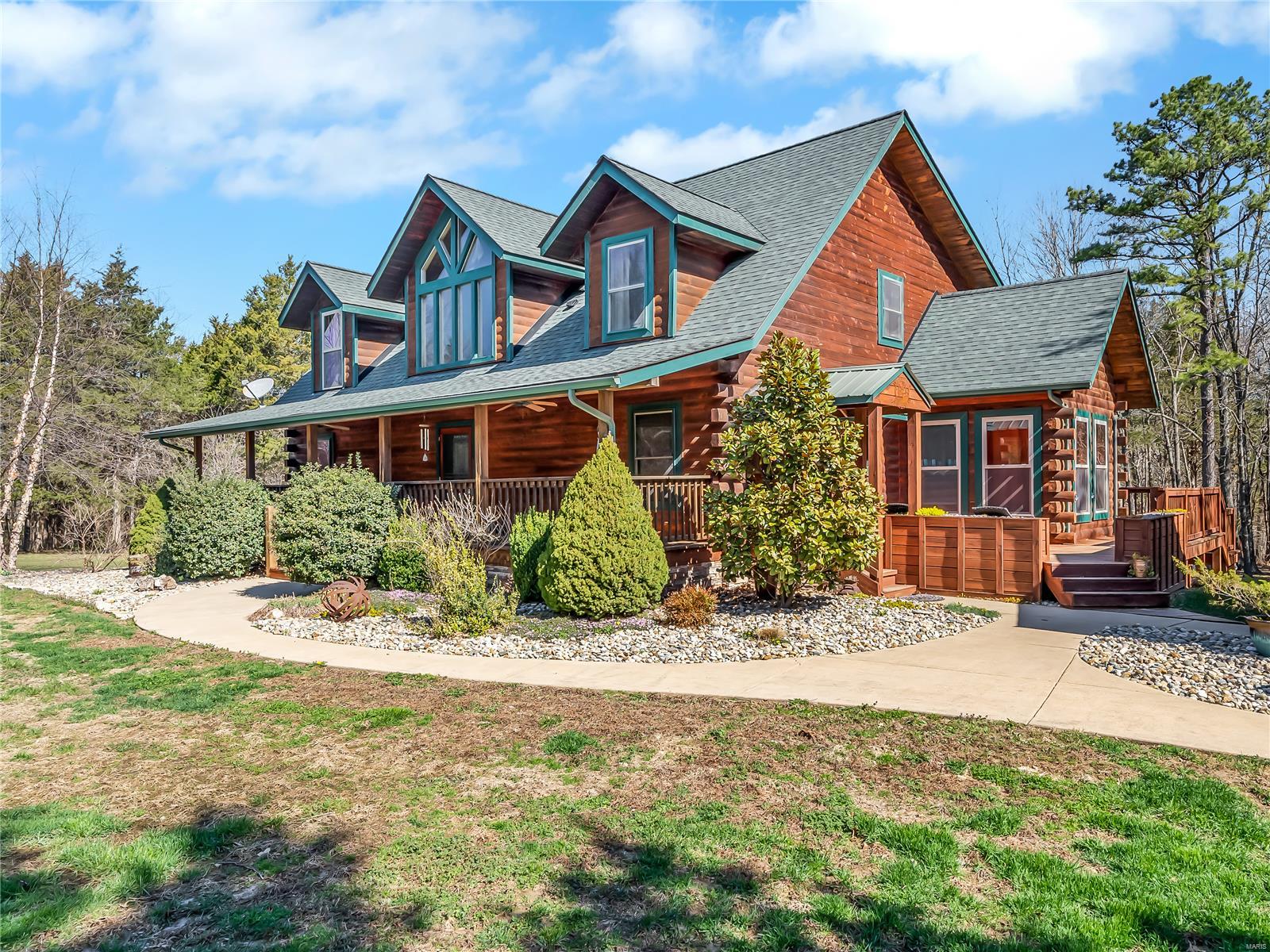 Exceptional 1.5 story Log home on just over 4 level acres has room for everyone! Featuring 4 large bedrooms, 3.5 baths and 3600 +/- square feet of comfortable living space, this place is the perfect family homestead. On the main floor you have a 2-story entry, great room w/ soaring ceilings, wall of windows and wood burning fireplace, kitchen with stainless appliances and custom cabinets, breakfast room with door leading to back screened deck and a formal vaulted dining area.  The  master suite features doors leading to the screened deck features and his/her closets and an on-suite bath.  Upstairs, you'll find a lofted catwalk with sitting area, 3 more large bedrooms featuring live dormers and 1.5 baths. The walk-out lower level includes a rec room w/ bar, a full bath, possible sleeping room (currently the hunting/ gun room) & a hobby area / workshop. Don't miss the patio, 2 car garage, extra tall carport for rv/boat parking & the amazing setting!  This is one you'll want to see ASAP!