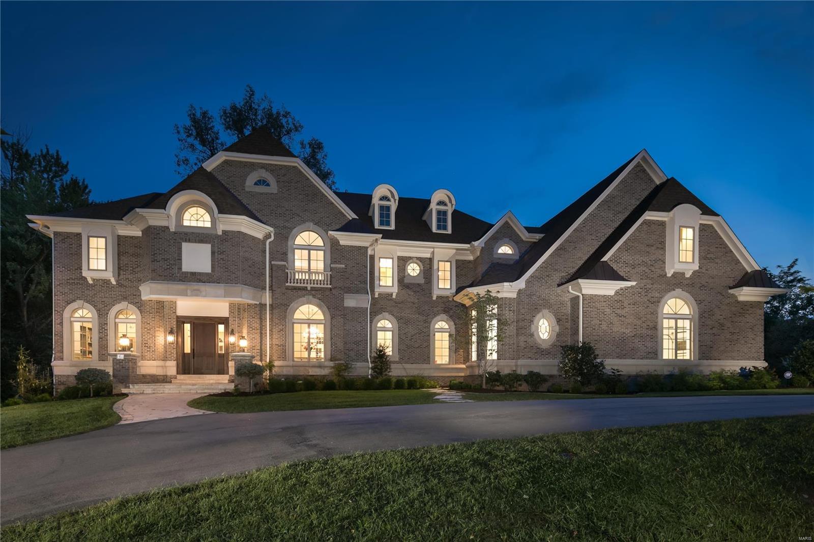 Be first to occupy this luxurious new construction executive home in Ladue.  Originally designed and constructed by a private party, as a true custom home, not a spec, by R.G. Apel Development. Details and finishes are at absolute highest levels, with both exteriors and floorplan that are fresh and not duplicated. Exceed your expectations with 12+ foot ceilings, extravagant crown/picture moldings, oversized windows, designer lighting and surround sound. The Main level offers office, dining room, living room, 2-story hearth room, and cutting edge kitchen outfitted in glazed cabinetry, high-end appliances, marble and quartz surfaces. 6,500+ SF of finished living space, with a perfect brick enclosed outdoor space. All bedrooms on second level, serviced by elevator, with a master suite encompassing an entire wing. Three additional en-suite bedrooms. Rec/media/game room easily converts to 5th bedroom. Prime Ladue location adjacent to St. Louis Country Club, minutes from downtown Clayton.