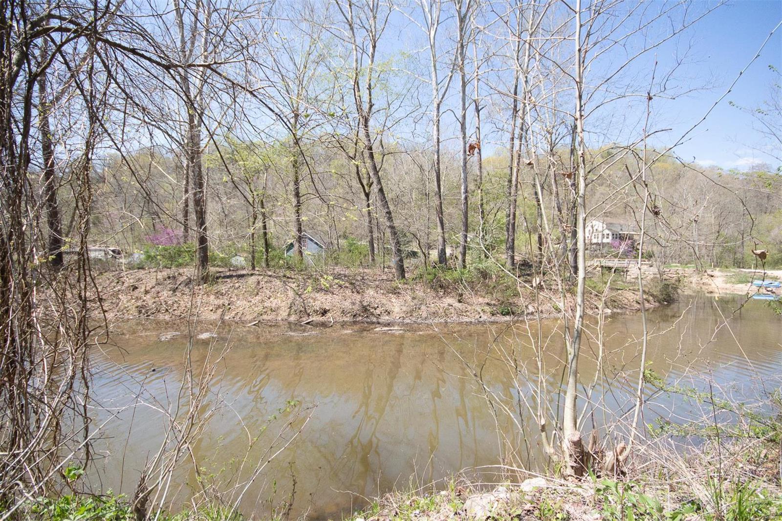 Gorgeous lake front lot off of Bluffview Drive.  Most of the 3.49 acres sits on top of the hill on Country Hill with a nice building site along with a meandering dry creek.  Enjoy recreation and nature!  Fishing, boating and much more in this private resort like subdivision that is situated around a 130+/- acre lake.  Enjoy the swimming beach, boat ramps, camping and public pavilions.  Your builder, your plans - or just keep it as a weekend retreat as it sits.  Campers/RV's welcome.