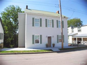 Wonderfully renovated all-brick 3-bedroom, 1.5-bath home in New Haven's historical district! You will fall in love with the tall ceilings, laminate & ceramic tile flooring throughout, exposed brick feature walls, built-in bookcases, and more! The large living room will easily fit your oversized furniture & open spindle staircase makes the room feel even larger. The den off the living room is a great space to have a private office, craft room, or kids playroom. The kitchen/dining combo is HUGE! Updated cabinetry & breakfast bar make the space user-friendly. The dining room offers additional seating. The covered deck off this room is great for summertime barbecues & entertaining. A half bath is also located on the main floor. Upstairs, the large master bedroom easily fits a king-sized bed plus several dressers! An enormous walk-in closet is offers additional storage. Two guest bedrooms & a hall bath are also on this level. A large attic offers even more storage. Schedule your tour TODAY!