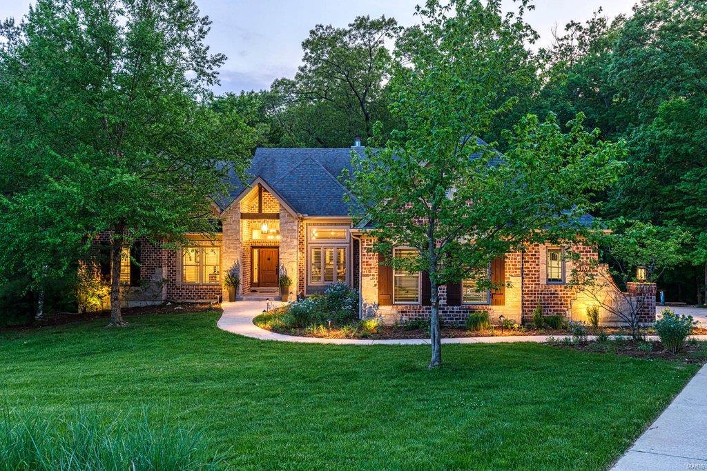 Spectacular atrium ranch with over 4600 sq ft of living space enhanced by superior craftsmanship & distinctive architectural elements throughout. Expansive windows capture intimate views of the natural surroundings while beamed ceilings, hickory hardwoods & designer lighting provide a sense of rustic elegance. Impressive entry foyer leads to formal dining room & stunning great room highlighted by floor-to-ceiling stone see-through fireplace. Karr Bick-design kitchen with Mouser cabinetry, soapstone countertops, commercial grade appliances & wet bar adjoins breakfast room with stone fireplace, 10’ island & copper sideboard. Vaulted master bedroom suite with wide bay window & marble bath with freestanding tub plus 2 additional bedrooms & hall full bath complete the main floor living quarters. Walk-out Lower Level includes recreation room with wet bar, game room, media room & guest suite. Situated on 3+ wooded acres with screened porch, 2 decks (1 with fireplace), fire pit & 4-car garage.