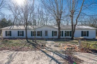 4 Bedroom, 2 full bath, 28x80 manufactured home with 2,240 +/- sq. ft. Home sits on 1+/- acre, stone wood burning fireplace, open floor plan, cathedral ceilings, separate dining room, detached 1 car garage, circle drive. Kitchen with center island, breakfast bar, all appliances stay, washer and dryer stay, attic fan. 33 ft above ground pool, priced to sell! Roof 4+/- Years, Well 3+/- years.