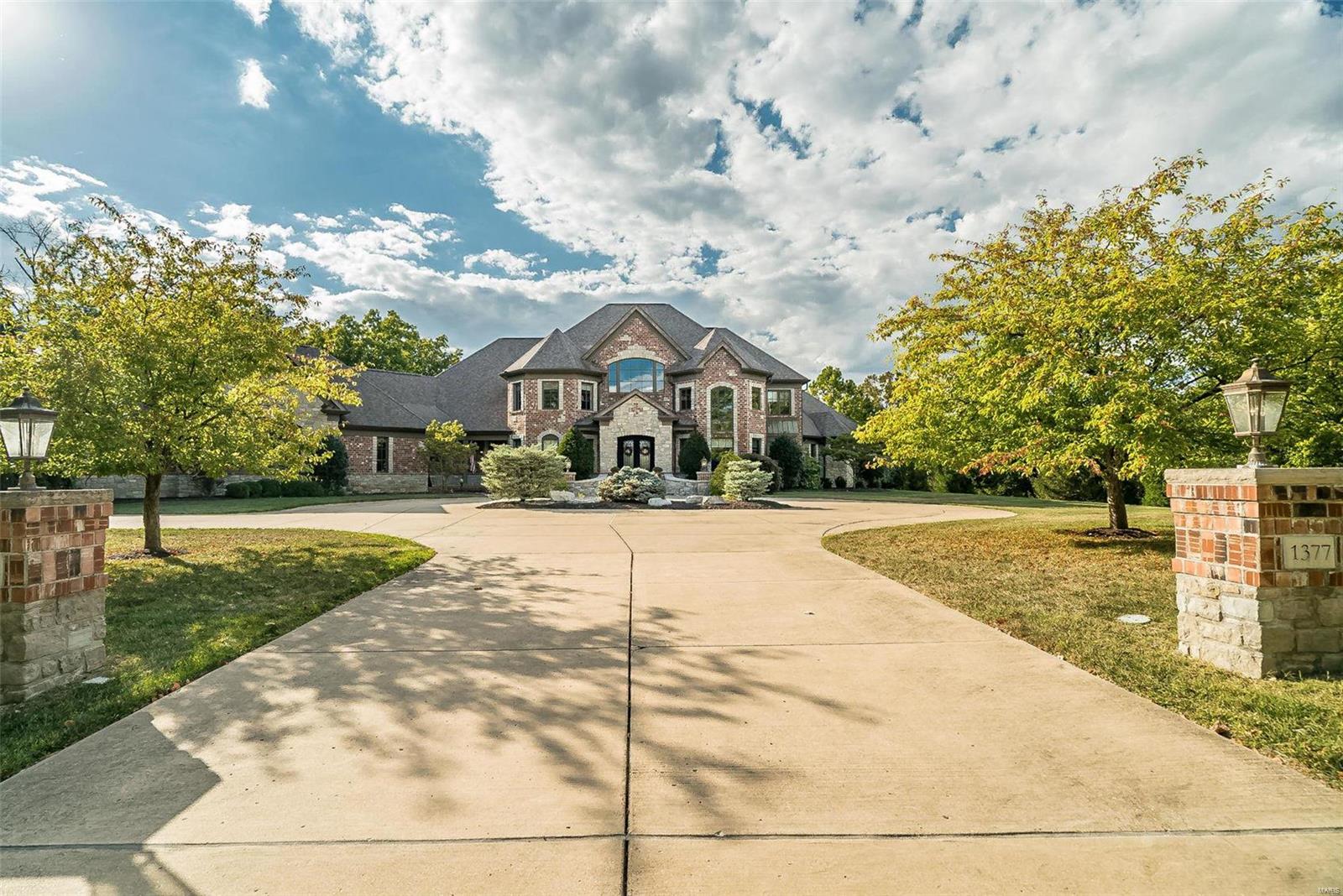 First time on market, this one-of-a-kind 3.3-acre estate was designed and custom built for this lot. Bordering Queeny Park, this property offers extraordinary outdoor amenities and next-level privacy. Massive 2-story foyer with timber beams through the main part of the house to the great room with two-story stone fireplace. Study has 14' ceiling, fireplace and adjacent coffee bar. Designer kitchen with custom cabinetry, granite countertops and stainless appliances adjoins breakfast room and hearth room with vaulted tongue-and-groove ceiling and stone fireplace. Primary bedroom suite has see-through fireplace, steam spa shower, and private deck overlooking backyard. Lower level has main rec room with fireplace and wet bar, theatre room, weight room, billiards room, craft room, bedroom and 2 full baths. Outdoors include in-ground pool with water/fire feature, tennis court, and 2000+ sq ft of covered outdoor space with massive stone columns that have to be seen. Showings begin 10/12.