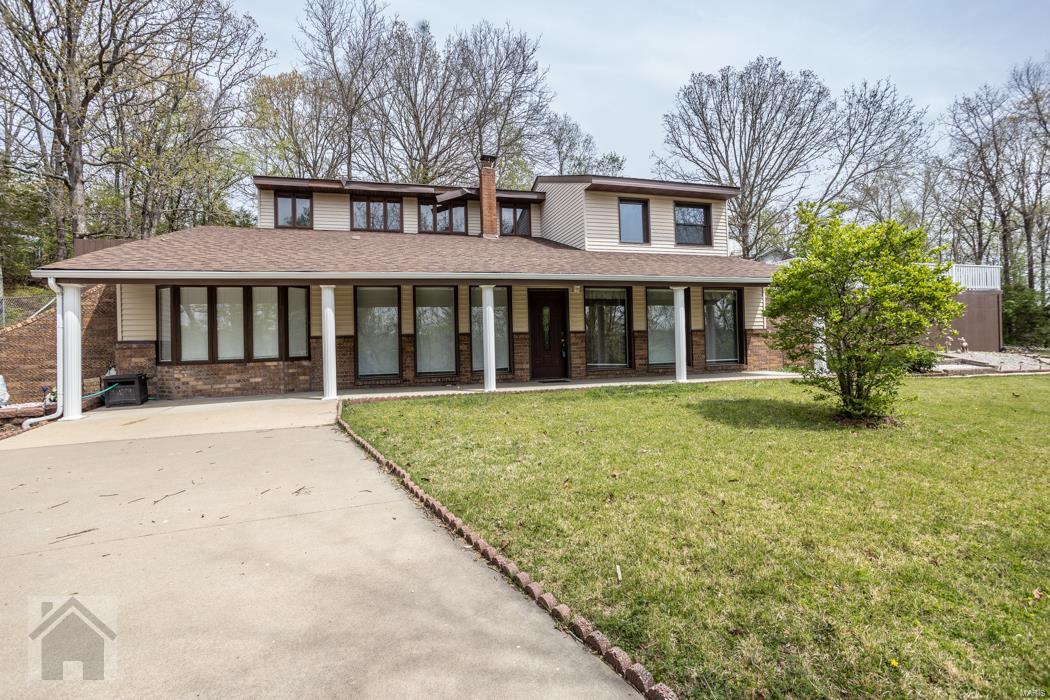 ONE OF A KIND! This secluded 1.5 story house is quite unique - with brick columns in the formal living room, a covered concrete front porch for the entire length of the front of the house, the massive concrete deck & the owner suite w/private spa tub and built-in wall of closets - this house is distinctive & well cared for. There's a cozy family room compete w/wood pellet stove, wood paneled ceiling & built-in brick shelving open to the eat-in kitchen & plus a formal dining room. Upstairs is a large office area w/wood ceiling, the owner's suite & laundry room that exits to the deck. The attached bath has a jetted tub in its own private room & separate room for the toilet & tall vanity. The main floor guest bath has a granite topped vanity. The 2 large main floor guest bedrooms both have sun windows. The whole yard is surrounded by a wall of trees! You'll feel like you're living in the country! Square footage & measurements approximate REF DSC-8001. Let’s talk about a showing!
