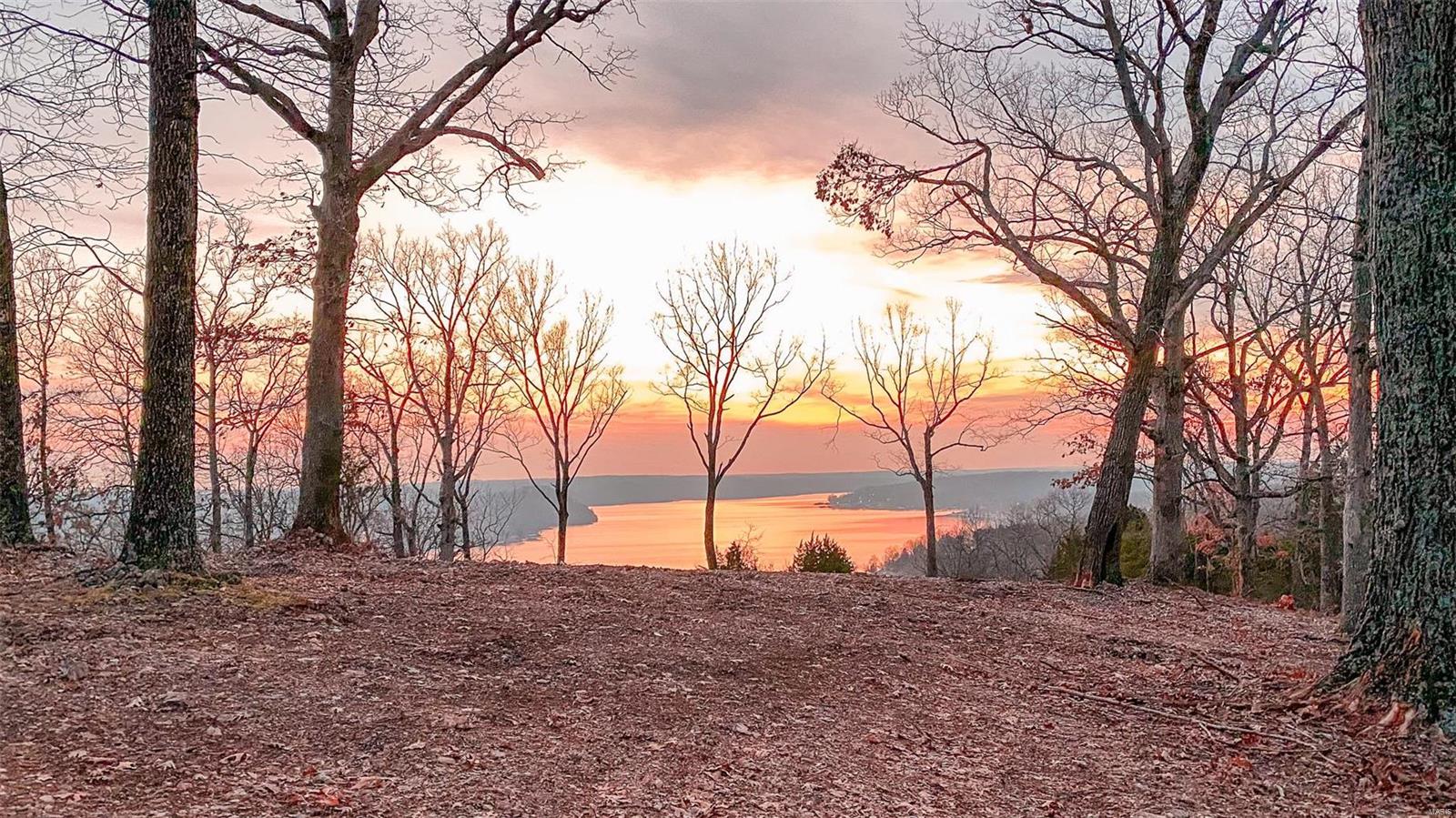 If you’re here for the view, you’ve found it. This 30 +/- acre tract of land at Lake of the Ozarks has one of the best west-facing, main channel views money can buy. The sunsets here are stunning and you’ll be able to enjoy them year-round, overlooking the quiet 46 mile marker. Hardtop road takes you all the way to the property. A cut-in driveway leads up to an awesome freshly cleared area where you will be able to build your dream home or cabin overlooking the lake. You will have multiple options on what and where to build here, the views are incredible and the possibilities are endless. There is a high population of deer and turkey in this area and the topography funnels them right through these 30 +/- acres. A recent select cut has made great cover and the ideal habitat they love to live in and use. This property sets up great for that lake-side tract you have been dreaming of. Here you can hunt, fish, ride, and reside all in one place!