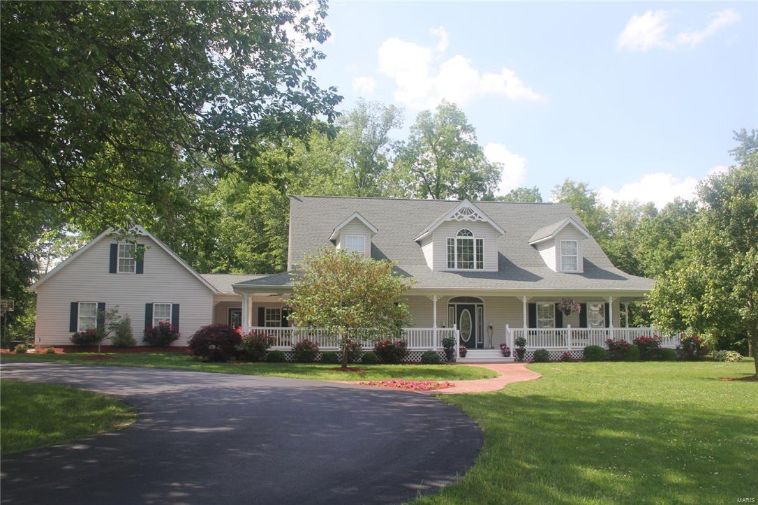 This gorgeous story and a half home lays on aprox. 1.78 acres featuring: four bedrooms, two and a half baths, 3 car garage and a 4 car detached garage that is heated/cooled with 3 phase electric. The open kitchen boasts ceramic floors, granite countertops, stainless steel appliances & more! Off the foyer is a spacious living room featuring large picture windows.  The master suite features 9 foot ceilings with crown molding & luxurious bath. The upper level has three bedrooms, and a full bath. Enjoy the spacious screened in porch looking over the beautiful landscaping which is perfect for summer entertaining! From the stunning wrap around porch to the totally private back yard this home is outstanding.
