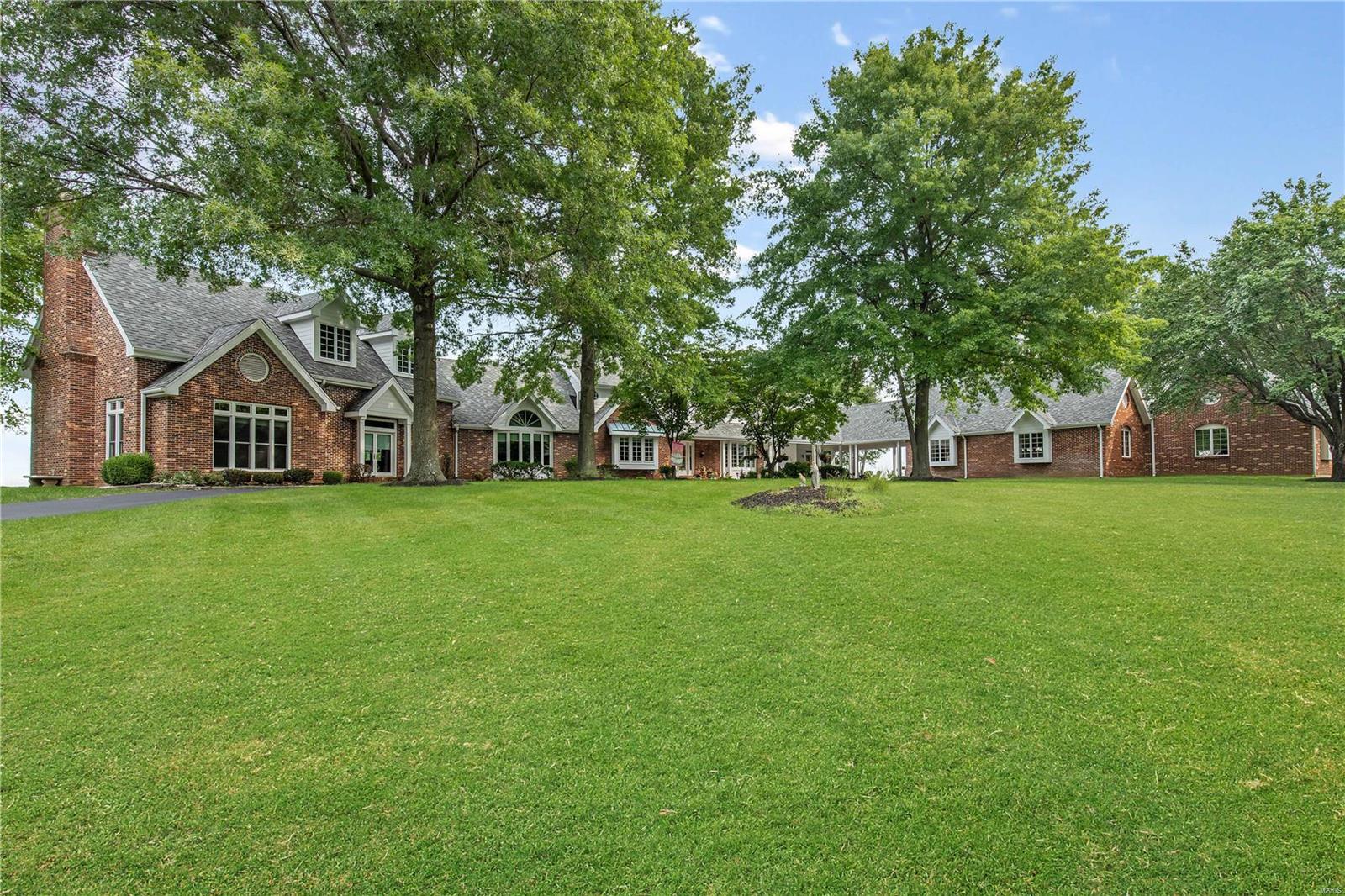 One of the landmark country estates off of Wildhorse Creek RD. Majestic 9 ac +/- property with  1.5 story Colonial w/ vistas overlooking the Chesterfield Valley. No need to look any further,This 5 BR boasts of a 2 story entry foyer , a solarium leading to the huge great rm ideal for large gatherings and a  step down living room w/ beamed vaulted ceilings, wet bar & windows that overlook the amazing infinity pool. Beautiful open kitchen w  granite counter tops, stainless steel appliances, walk in pantry, breakfast rm & charming hearth room.Privately situated main floor master suite has a coffee counter,a fireplace, plus, his & her separate baths, dressing areas, plus a 2nd washer/dryer.The 2nd floor offers 3 more BR & 2 full baths.One of a kind walkout finished LL with a large Rec Rm,  many options of a BR, office, kitchen, dining area, exercise room, full bath, half bath & steam shower.6 stall barn for horses.5 Car garage. THIS ONE OF A KIND SPECIAL PROPERTY WILL BE YOUR LIFESTYLE! Additional Rooms: Sun Room