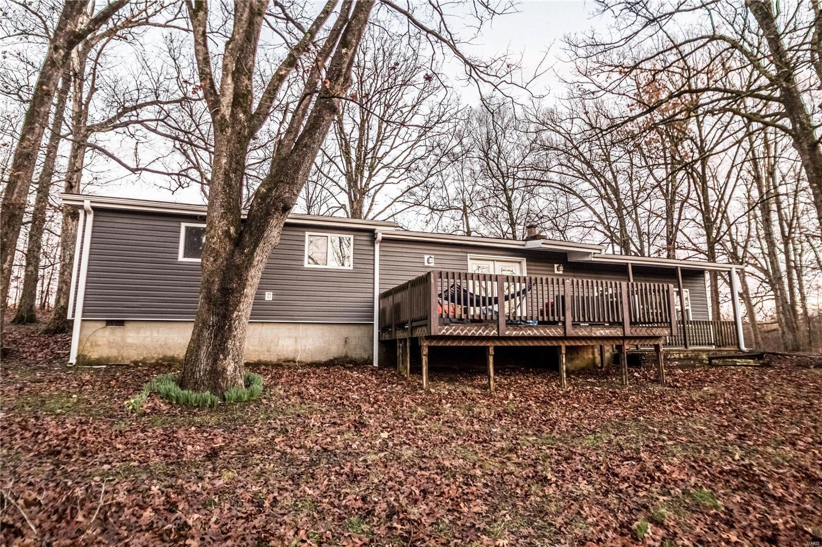 Located South of Poplar Bluff off of CR 4761 sits this 3 could be 4 bedroom, 3/4 bath home in a private setting. This home sits on just under 1 Acre. This home features vaulted ceilings with real hardwood floors, fireplace in the living room, as well as a large kitchen. Additional features this property offers is an updated kitchen and an extra large front porch for afternoon Sweet Tea Sipping.