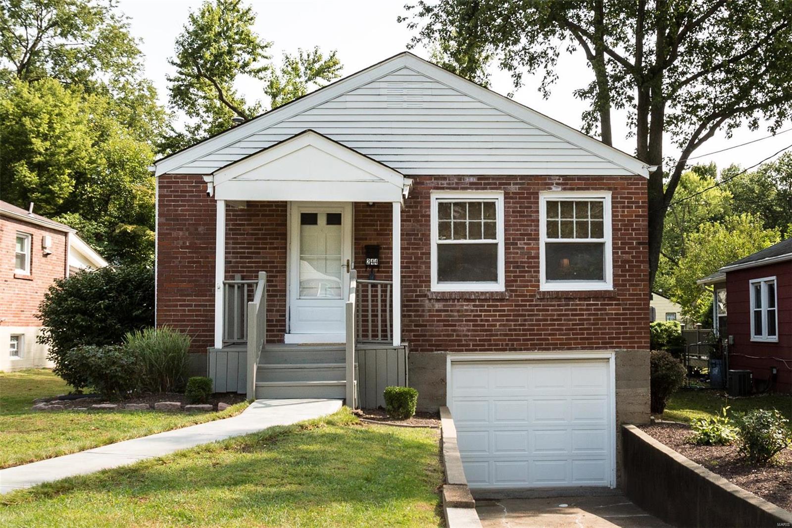 Hello adorable. Tiny but large on cuteness this little brick home has everything you need. Two bedroom, one bathroom with one car tuck under garage and huge, level, fenced yard.  Beautiful hardwood floors throughout living, dining and bedrooms. Natural light filled and the perfect starter home.  Partially finished basement with plenty of storage space too. Close to everything Ferguson has to offer. Parks, shopping, brewery and dining.