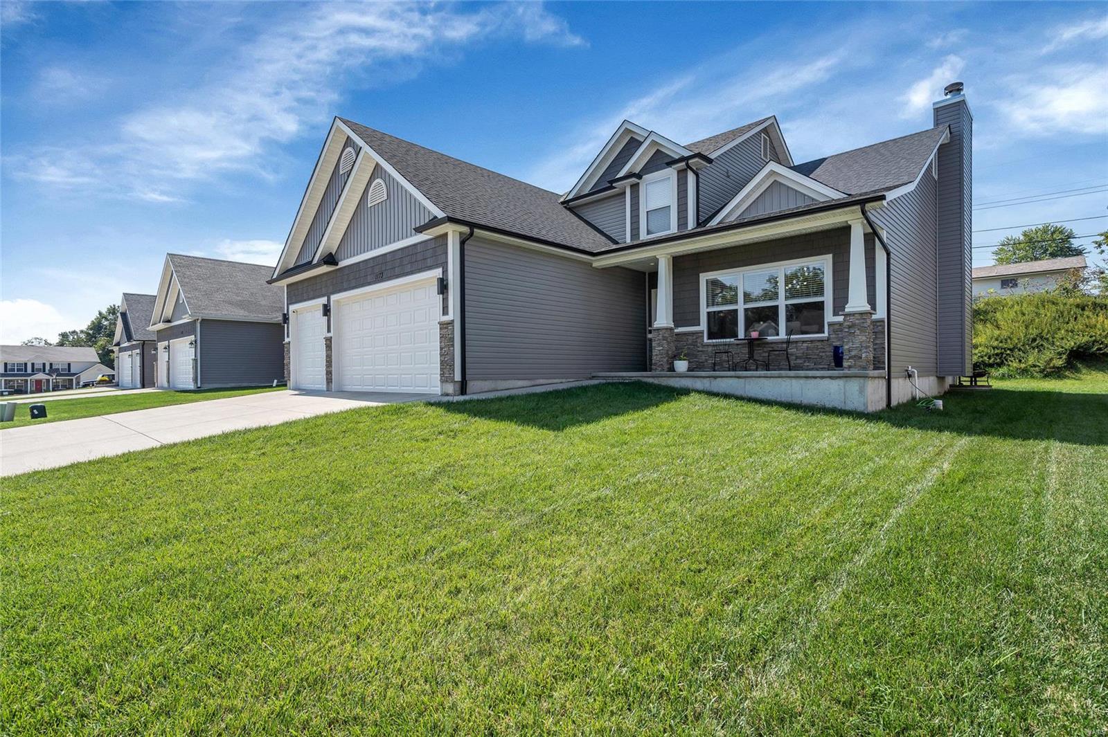 Welcome home! This stunning home in Foxwood Estates makes quite the statement! Upgrades include engineered wood flooring, cathedral & 9' ceilings, 3 car garage w/ 8' doors, and additional 2' depth. The spacious open floor plan includes a custom kitchen layout designed by the owner boasting 42" cabinets, custom range hood, huge center island & upgraded recessed and pendant lighting. Enjoy the flow to the great room complete w/ wood burning fireplace and 3 transom windows.  This space is perfect to host family and friends for any event!  The large master ensuite offers luxury and comfort w/ adult height double vanity and separate tub & shower. So many perks have been added including, but not limited to: 4' extension in the living room, 2' bump out across entire back of the home, additional 1' bump out to LR and DR side, spray-in cellulose insulation package, upgraded architectural shingles, & smart home system complete w/ Nest thermostat! Make this show stopper YOUR dream come true!