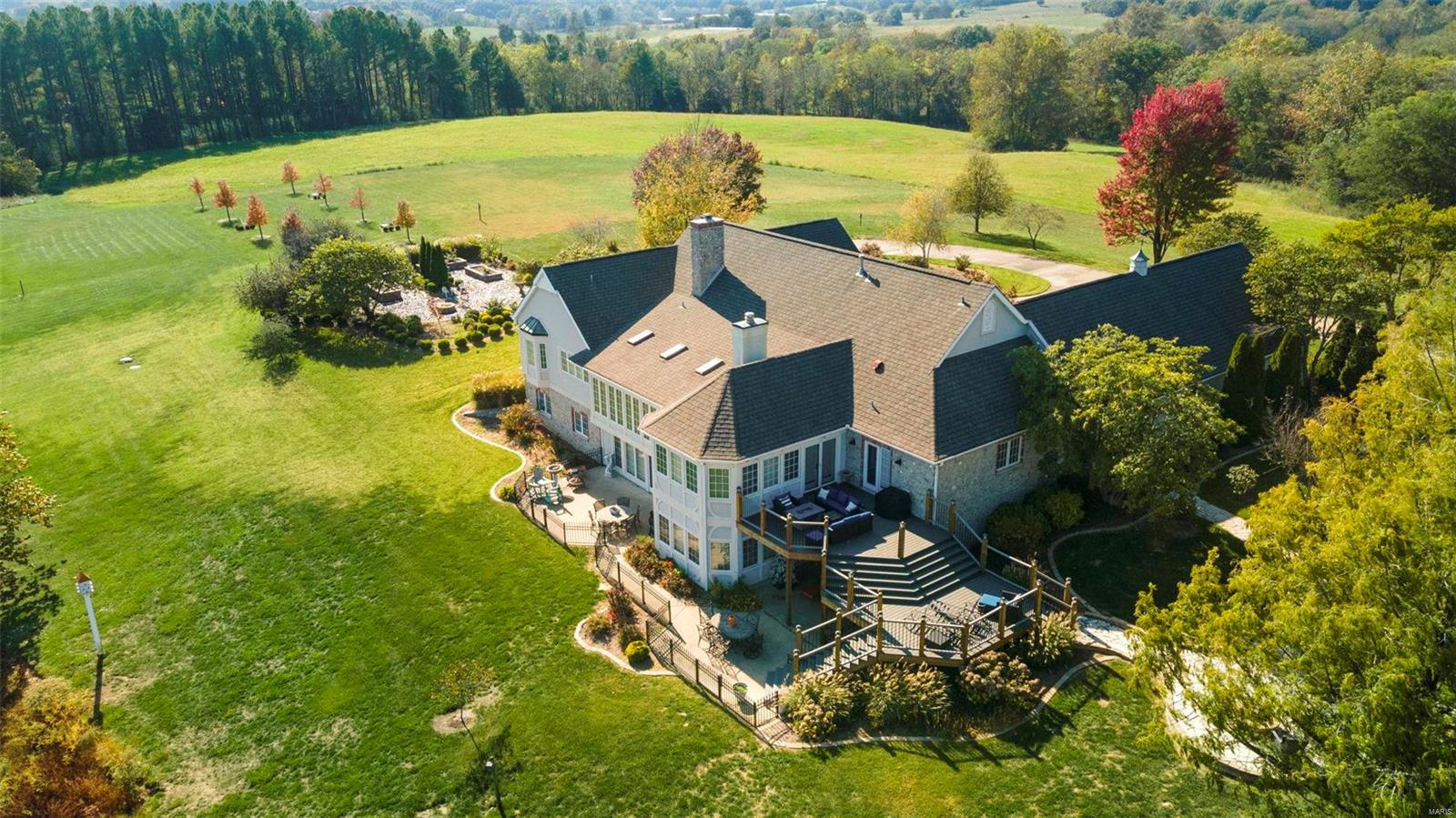 This stunning home is located on over 12 ac in the beautifully designed Dux Landing Subd. Every detail has been meticulously crafted & brings to mind the charm of a Thomas Kinkade painting. The property features newly designed landscaping that flanks the home's North & South sides. Your time outside can be spent on any of the numerous patio/deck areas or at the private fishing dock. Two sets of French doors open from the great room into the sunroom which offers gorgeous views of the lake. The remodeled primary bathroom offers several amenities including radiant floor heating & a steam shower. Warm up this winter next to one of the 2 fireplaces. For the culinary enthusiast, the home includes a butler's pantry, a separate dining room, & a spacious spice room all w/ new quartz countertops, sinks, & faucets. The expansive walk-out basement, equipped w/ a kitchenette, offers endless possibilities-whether it's a game room, guest suite, or home theater, this space adapts to your lifestyle. Additional Rooms: Sun Room
