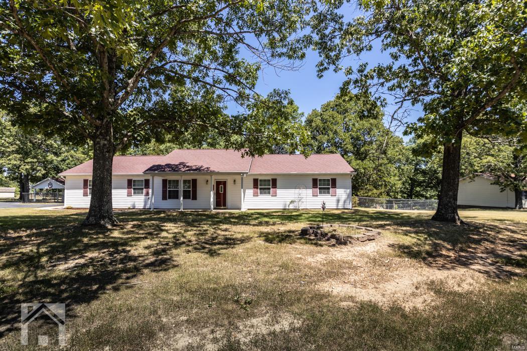 Beautiful country setting located in St Robert and within 10 minutes to the front gate of FLW!  This 3 bedroom, 2 bathroom ranch style home is located in the Waynesville School District and is on 2+ acres of land.  No carpet throughout the home makes for easy clean up.  Kitchen features plentiful cabinet space & countertops and white appliances.  Master bedroom suite features a walk in closet, ceiling fan, and updated vanity/walk in shower.  Two additional guest bedrooms both have ceiling fans and share a guest bathroom.  Additional features include a washer/dryer, 2 car attached garage and 1 car detached garage, covered back patio and porch, and large fenced in yard.  Don't miss out on your opportunity to own this wonderful piece of property. Call today to get your showing scheduled!