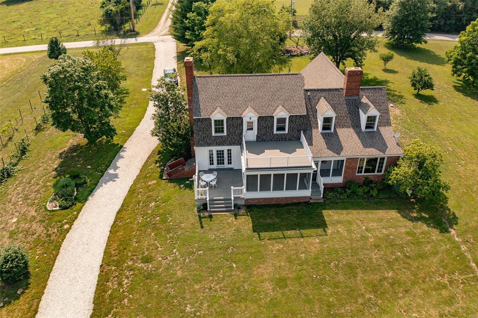 Private, off the grid, 16.5+/- level acre equestrian/fishing property w/a 1.8 acre stocked lake & 60’x36’ barn w/electricity & water. Fruit producing trees, blackberry bushes & a grape vineyard. Perfect for a weekend get-away or everyday living. Charming 4 Bedrm, 3 full & 1 half bath Cape Cod style home w/2,798+/- sqft. Walk into the foyer w/hickory wood flring through-out most of the ML. Home boasts formal dining rm, sitting rm w/full masonry FP, living rm w/2nd full masonry FP, walk-out to spacious screened in porch, wood ceiling w/wood beams, & windows. Kitchen features a wood ceiling, breakfast bar, & is equipped with a new dishwasher, double oven, electric cooktop, & new over/under cabinet lighting. Bedrm & updated laundry complete the ML. UL extends living quarters w/3 add'l bedrms, bonus rm, & large storage rm. Master suite boasts private deck w/new composite decking, 2 closets, & bath w/jetted tub/shower. Unfinished basement has great potential for additional living space.
