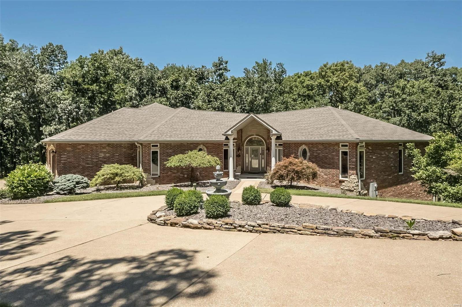 Discover serenity just 15 minutes from 270 & 44 in the heart of Greenfelder Park within prestigious Bridlespur Estates. This expansive 6,000 sf, 3 ace retreat is the perfect blend of city proximity and country tranquility. Custom architecture and exquisite millwork define this sanctuary.  The main level features a glorious great room with expansive 10' windows, a dream kitchen complete with butler's pantry, a cozy hearth room, and sun-kissed 4 seasons room. The owner's retreat offers a tranquil escape with its own fireplace, sitting room, and private veranda. Admire elegant ceiling details, luxurious hardwood floors, and 4 fireplaces. Lower level family fun center features state-of-the-art theatre, crafted by an Emmy-winning sound producer! Full bar also serves as a 2nd kitchen with Fisher&Paykel dishwasher, fridge, beverage fridge, 2 burner stove & warming tray.  Plus 2 ensuites & fourth bdrm. Walkout patio opens to flagstone patio. Your paradise of privacy awaits! 3 sides brick/stone Additional Rooms: Sun Room