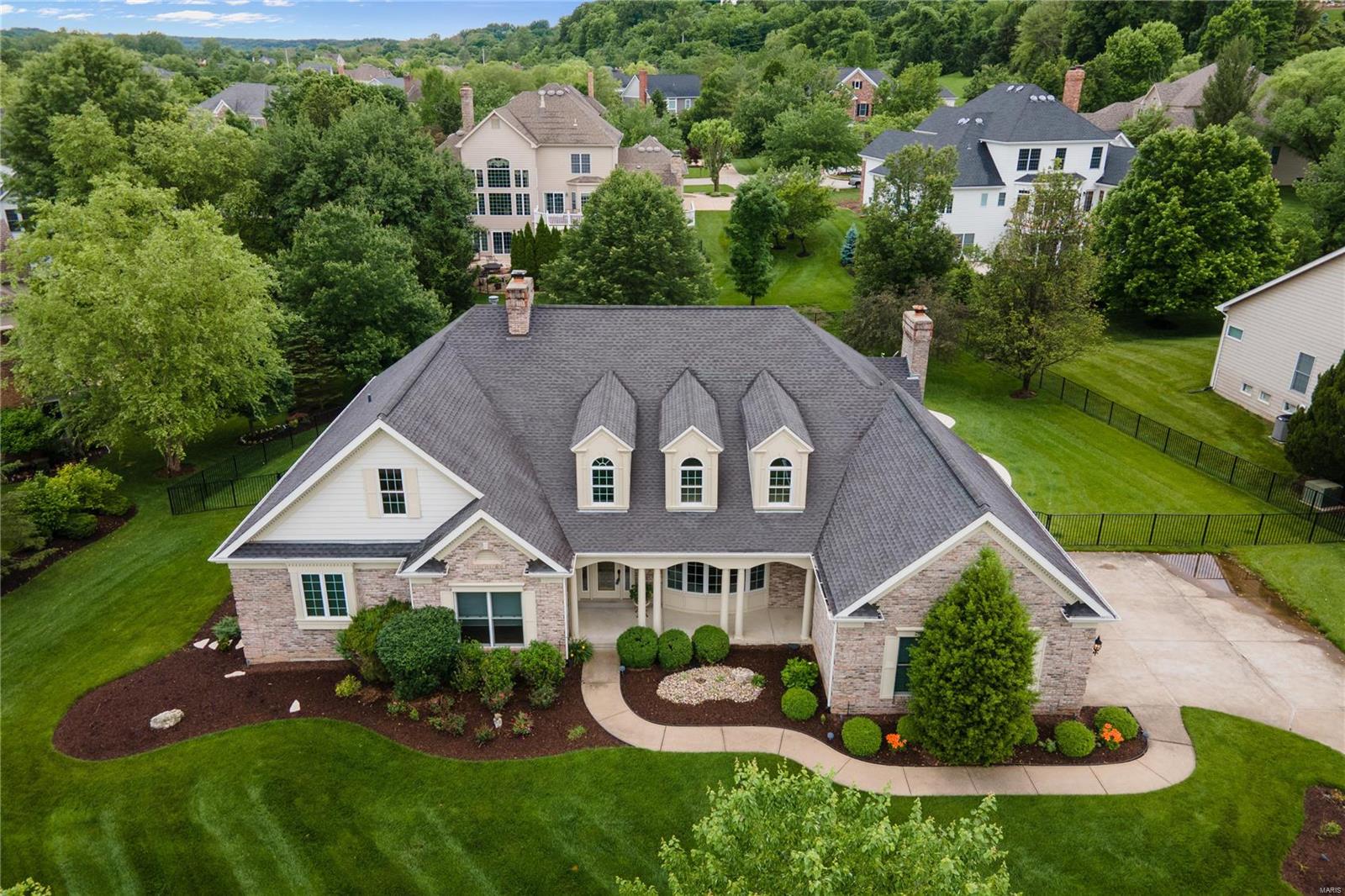 Breathtaking 5 bed, 3.5 bath ranch with finished lower level and in ground pool.  Marble entry foyer leads to the dramatic great room with coffered ceiling, built-in bookcases flanking the marble gas fireplace, wall of windows and hickory wood floors. Chef’s kitchen with custom cabinetry, granite counters, gas cook top, center island with breakfast bar, double wall oven, butler’s pantry, and planning desk. Adjacent is the breakfast room with access to the custom patio & vaulted hearth room with a 2nd fireplace and beautiful views of the backyard. Master bedroom suite with walk-in closets features a spa-like bathroom with dual sinks/vanities & separate soaking tub & shower. The finished lower level includes a huge recreation room, wet bar area, exercise room, 2 additional bedrooms, full bath, and media room. The spacious fenced in backyard is PERFECT for gatherings with family and friends as you enjoy the heated in-ground pool and custom stone patio, outdoor kitchen with sitting area.