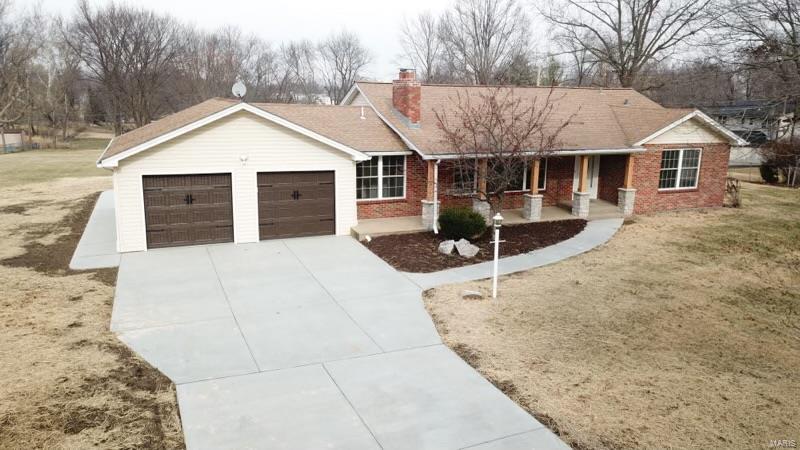 WOW! YOU MUST SEE THIS HOME IN PERSON! Sitting on 1.34 acres, this stunning home boasts more than 3000sqft. The home has been finished w/neutral colors, crown molding, hardwood flooring, & a well-laid out floor plan. In the living room, is a wood burning fireplace & a large window allowing natural light into the room. Down the hall are two bedrooms, both w/ample storage, & an updated bathroom. The kitchen draws you in w/the granite counters, sleek cabinetry, modern fixtures & SS appliances. This kitchen is a chefs dream! The window over the kitchen sink offers a view of the huge backyard. Off the kitchen is main floor laundry & a half bath. The family room has a slider leading out to a fabulous patio, perfect for entertaining, w/steps leading to a lower patio off the walk-out LL. Off the family room is the Primary Suite w/walk-in closet, electronics closet & gorgeous bathroom complete w/double sinks, modern fixtures & walk-in shower. The LL offers finished rec room & loads of storage.
