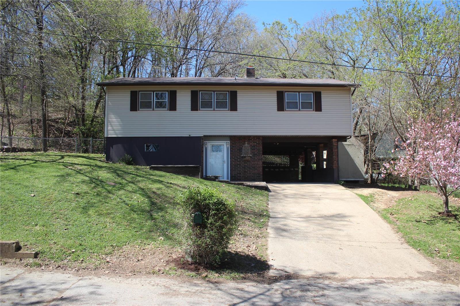 Charming two story home tucked away in a quiet subdivision! This home offers the convenience of being in the heart of Waynesville and only 6 miles away from the main gate of Fort Leonard Wood. With 3 bedrooms and 2 bathrooms, this is the perfect place for a new homeowner in any phase of life! The upper level of the home provides great space for family in the huge living room, and the perfect deck for entertainment. You will also find two bedrooms and a full bath upstairs. In the lower level, you have a great three piece bath and the third bedroom, along with the utility/laundry room. Add the space currently being used for storage that could easily convert to a bonus room and you've got everything you need! Call today for your personal showing! Sq ft and dimensions are approximate.