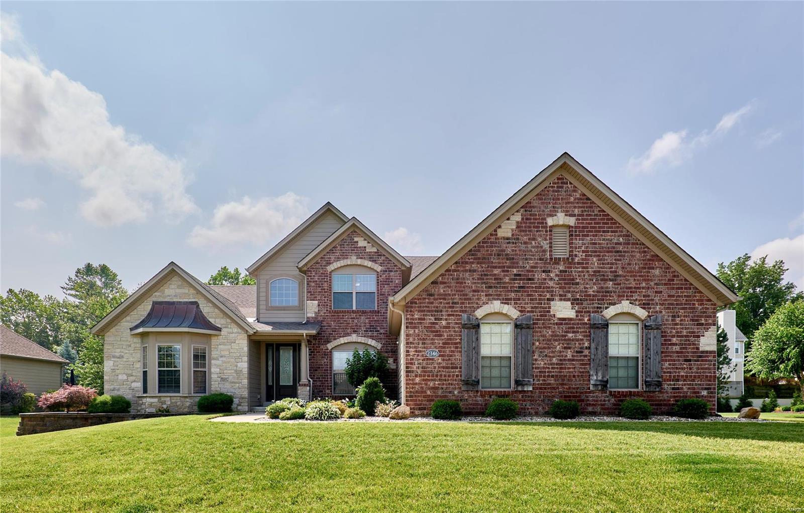 Here is your opportunity to live in the Impressive Gated Community of Spring Mill Estates! This Extraordinary Luxury Home has been meticulously cared for by the Current Original Owner and offers all the desired indoor and outdoor spaces to make this the perfect home for Entertaining! The Covered Porch Welcomes you into a large Main Foyer with Views of the Soaring Ceilings of this Spacious Residence. The Living Room, Kitchen and Hearth Room provide the perfect flow for Entertaining with 2 Gas Fireplaces and Access to the Beautiful Back Yard. The Covered Patio and Outdoor Kitchen with Inground Saltwater Pool has 2 Built in tables with seating, sunning deck, large shallow deck for kids and a Stunning 2 speed Waterfall. The Primary Main Floor Suite is a private Oasis with a bay door for access to the patio and Salt Water Hot Tub. High End Finishes too numerous to mention all, but does include a built in Vacuum System and Hardwired Landscape Lights. All of this included in a great location!