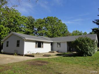 PRICE REDUCED!!!! 3 Bedroom, 3 Bath home only minutes from town! This perfect starter home is priced to sell quickly. Many updated features including a new propane furnace in January of 2015, new carpet in 2013, newer pressure tank, and a newly remolded bathroom in 2013. Extra large hallways and a bedroom that is wheel chair accessible. Your option of two master bedrooms, both with their own bathrooms. Large closets through-out the home for lots of storage. Partial basement and main level laundry area.  30' X 24' barn with chicken coop and a horse stall. 65' X 24' detached garage with electric and concrete floors.  Property is being sold AS IS. Great location in the R-80 school district!